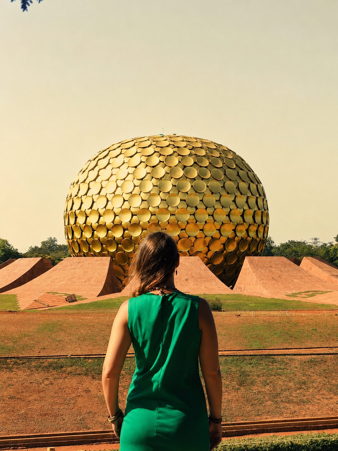 woman standing in front of golden temple with back toward the camera