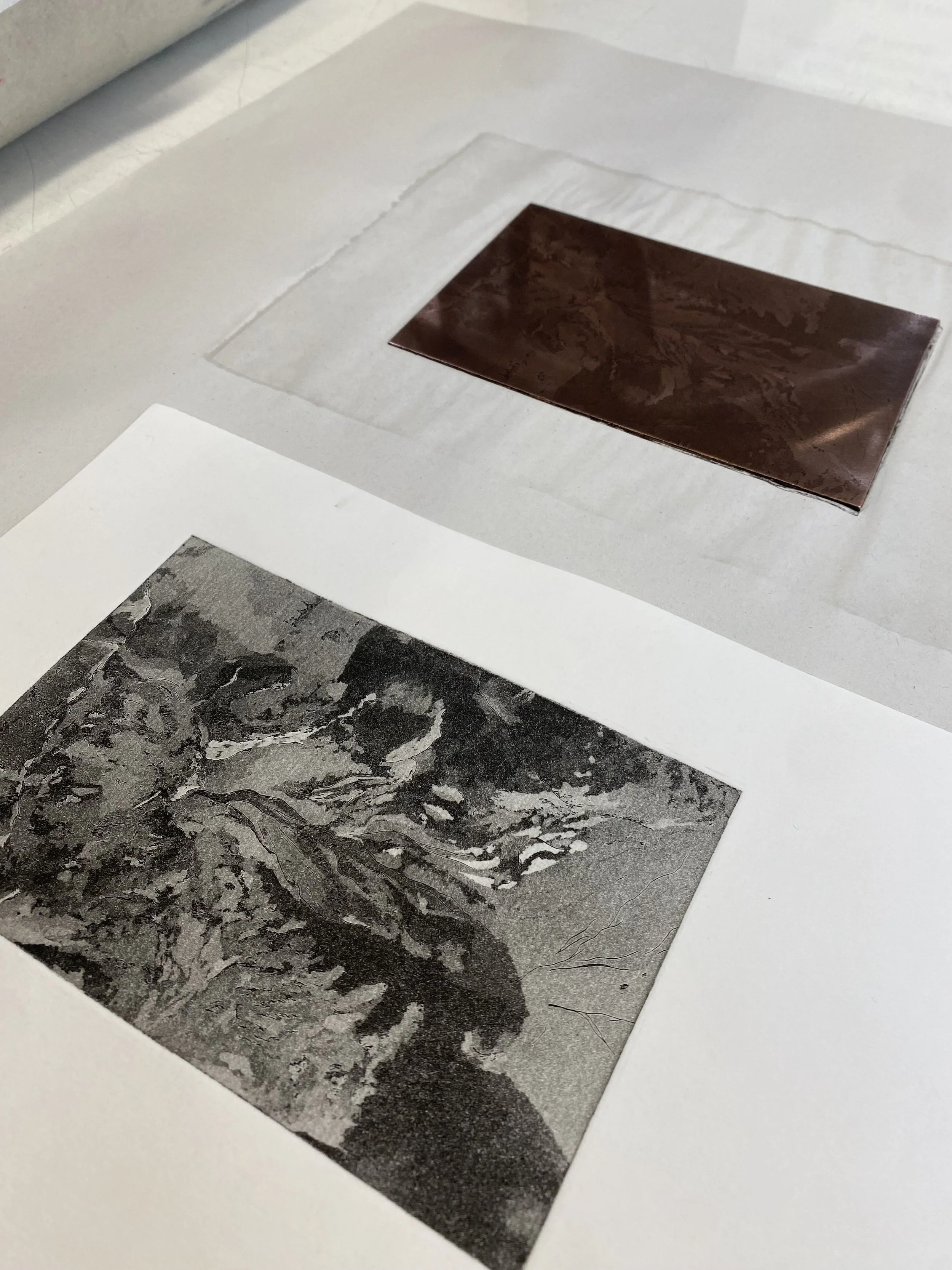 Close-up of a sheet of paper with a dark brown, marbled pattern sticker or image on a white surface.