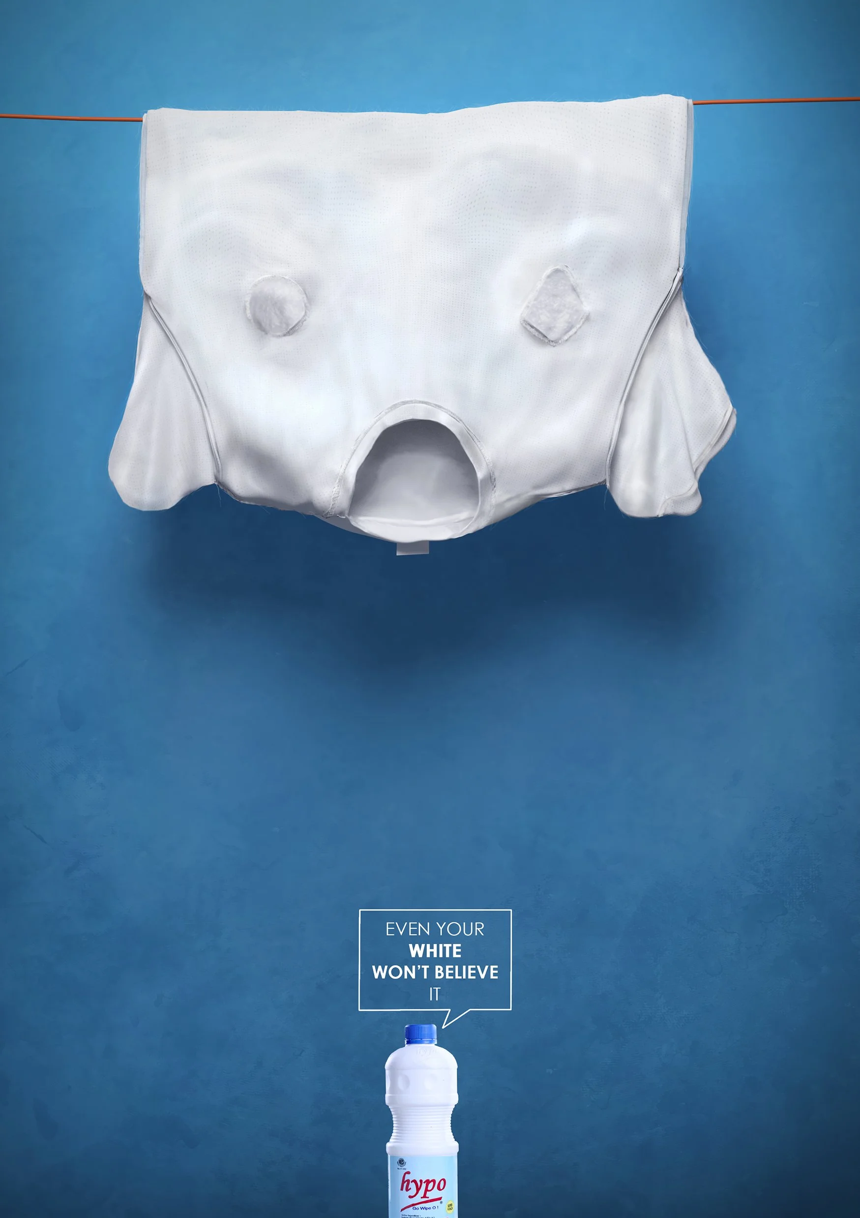 A white diaper hanging on a clothesline with a phrase below it reading 'Even your white won't believe it,' and a white spray bottle labeled 'hypo' at the bottom, set against a blue background. Best Art Director in Nigeria.