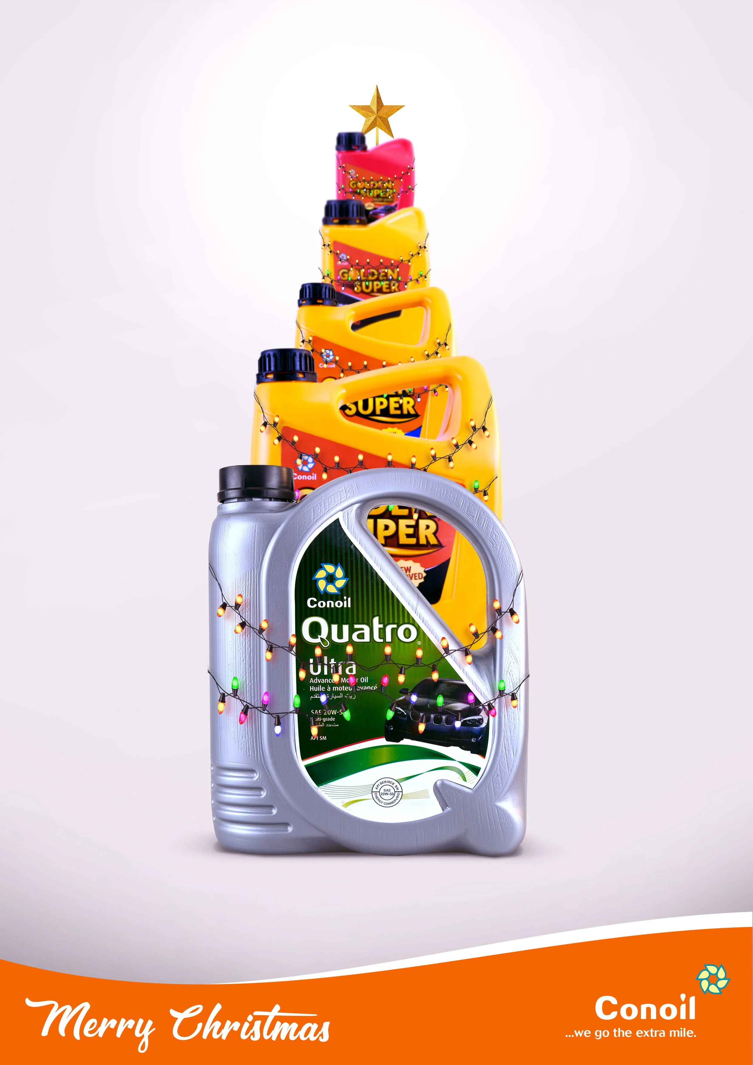A stack of motor oil containers decorated with Christmas lights, topped with a gold star, with a holiday greeting and the Conoil logo at the bottom.