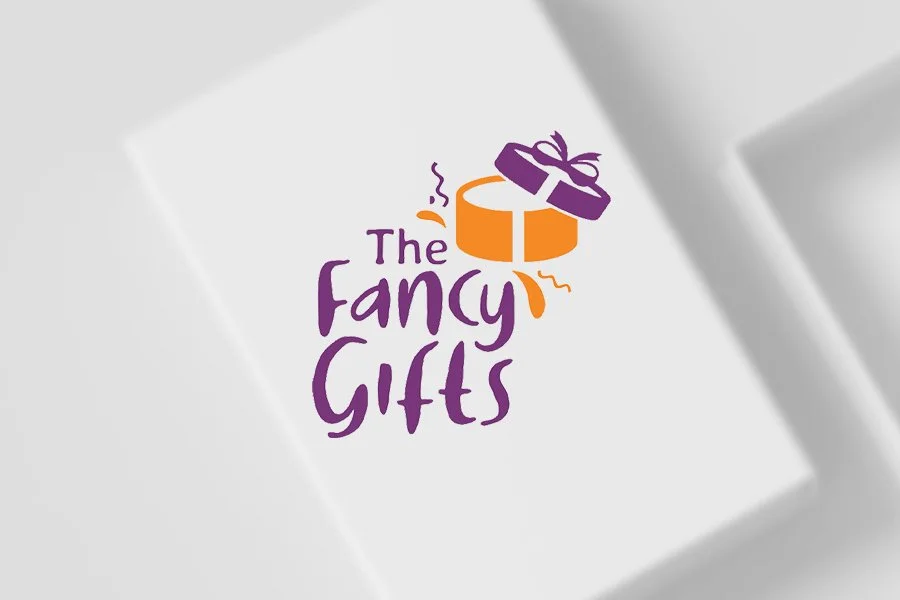 Logo for The Fancy Gifts featuring a purple gift box with a purple bow and orange accents, and the brand name in purple text.