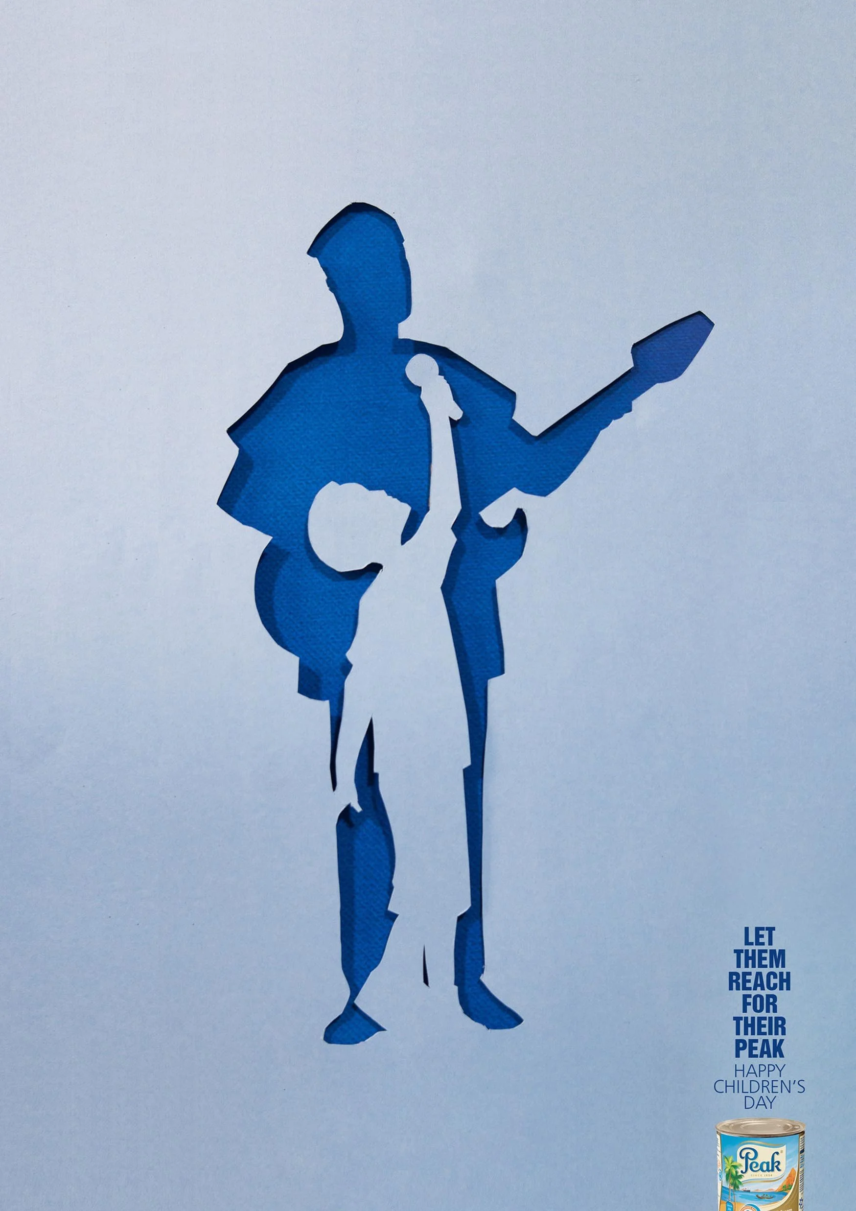 Blue paper cutout of a person playing the guitar with a message in the bottom right corner that says "Let them reach for their peak" and a can of Peak evaporated milk for Children's Day.