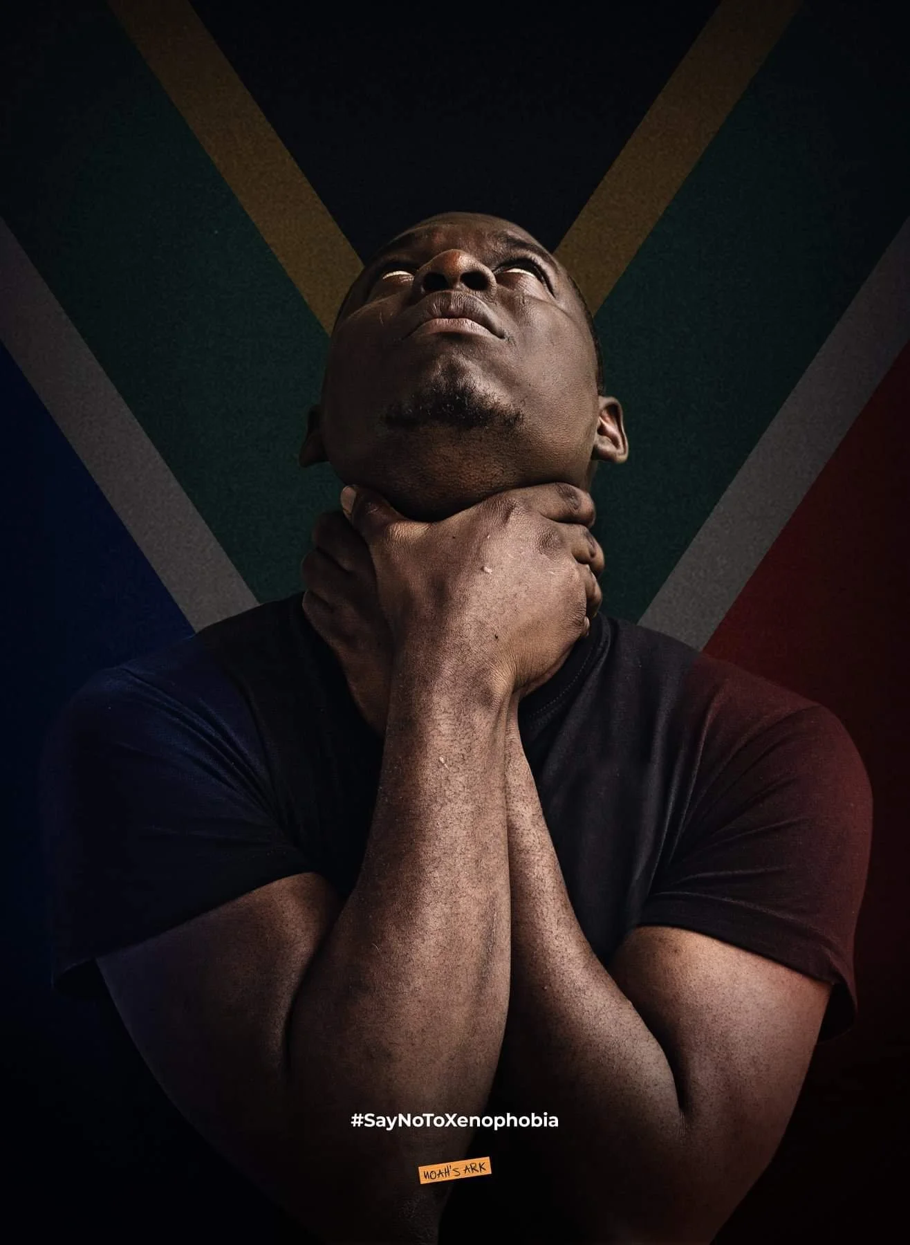 A person with dark skin and short hair holding their neck with one hand, looking upwards. The background features a stylized African flag with green, yellow, black, red, and white colors. The image promotes a message against xenophobia, with the hash