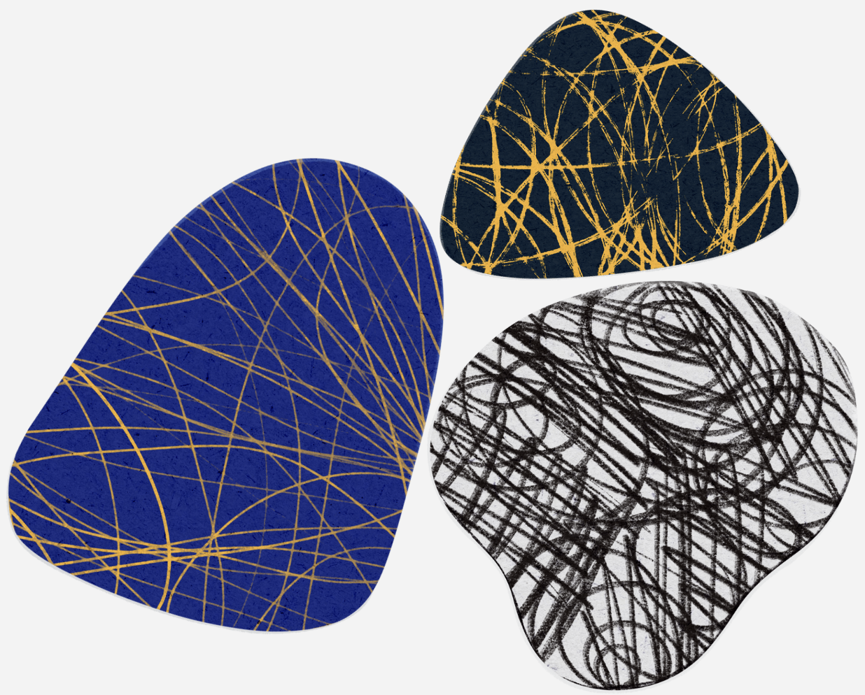 Three abstract guitar picks with chaotic line patterns. One large blue pick with gold lines, one smaller black pick with gold lines, and one medium white pick with black lines.