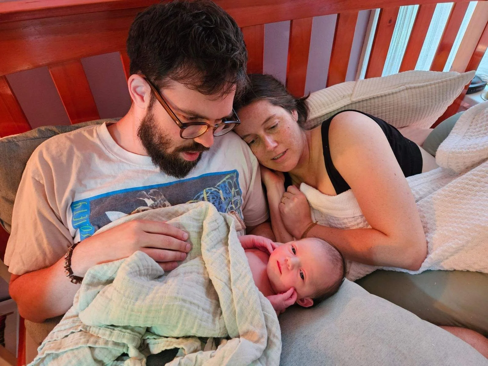 Lauren Akin, her husband Henry Jamison, and their daughter after giving birth at home.