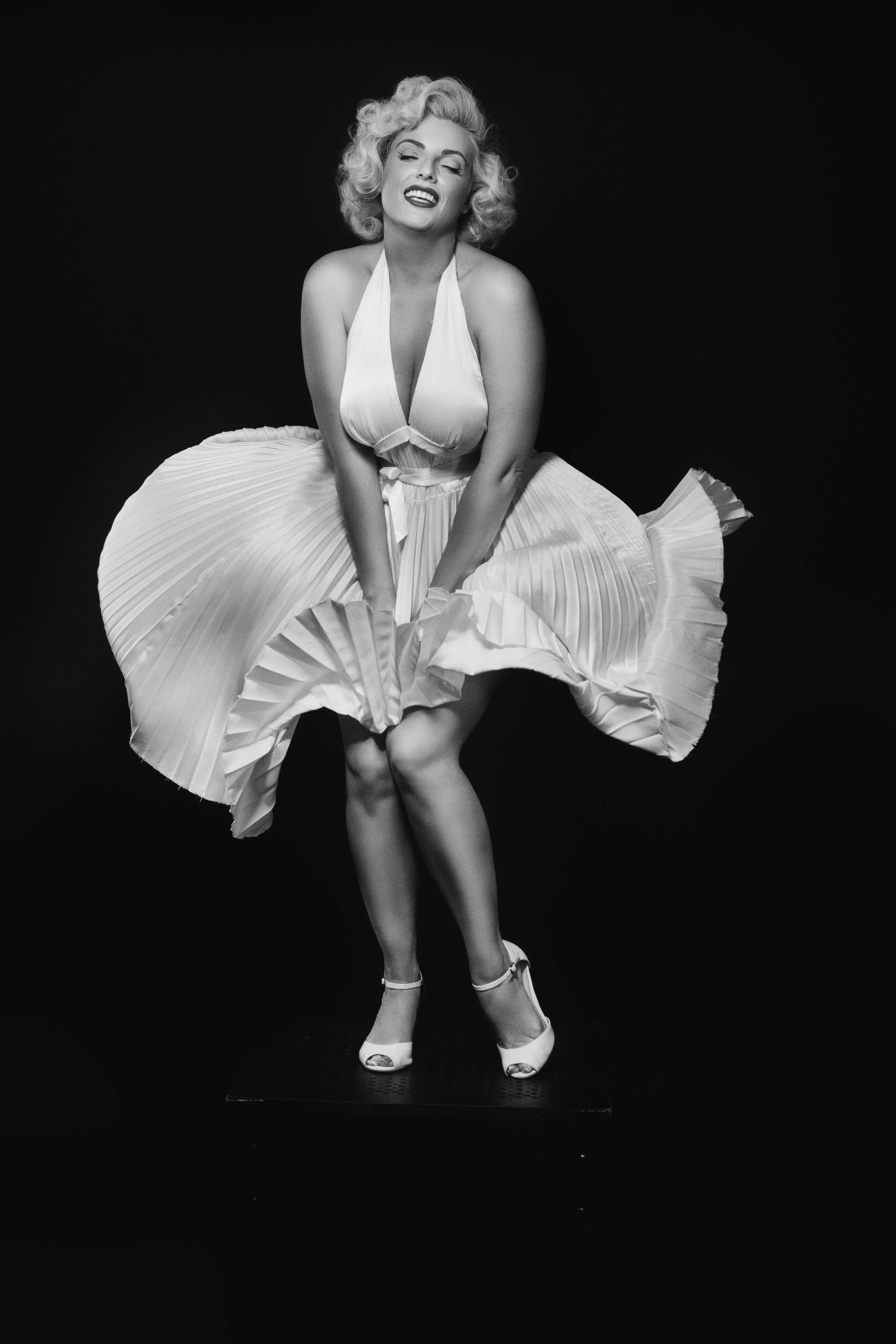 Marilyn Monroe lookalike Isabella Bliss recreating the iconic Seven Year Itch white dress pose
