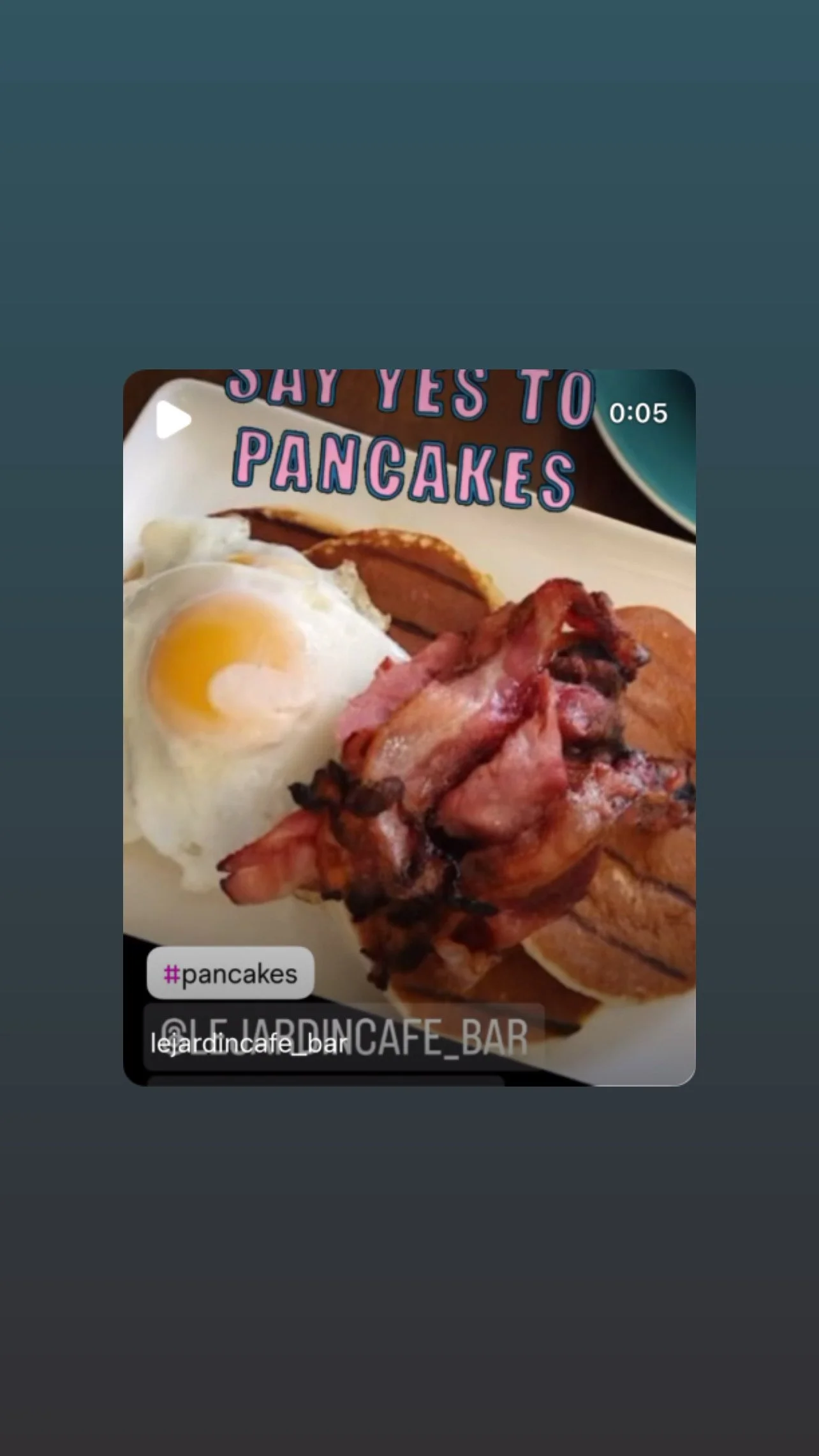 Plate with fried eggs, crispy bacon, toast, and pancakes with syrup, with text overlay saying "Say yes to pancakes".