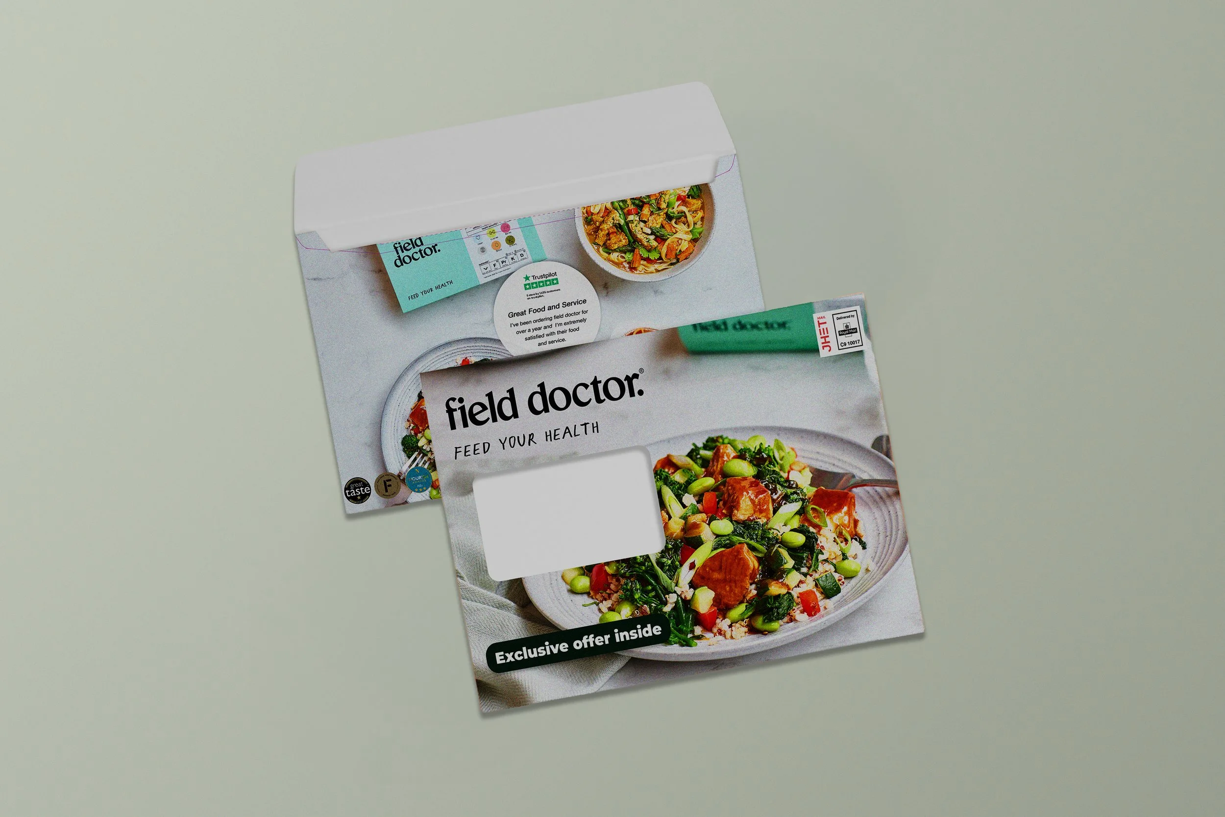 The image shows a partially opened box of 'field doctor' meal kit, with a bowl of prepared stir-fry and a food container inside. The packaging promotes healthy eating with the slogan 'Feed your health'.