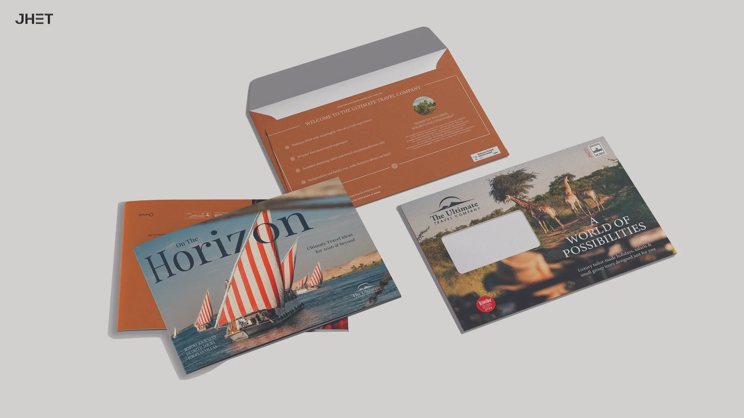 Brochures and flyers for The Ultimate Travel Company featuring travel destinations, including a beach with sailboats, an African safari with giraffes, and promotional text about travel experiences.