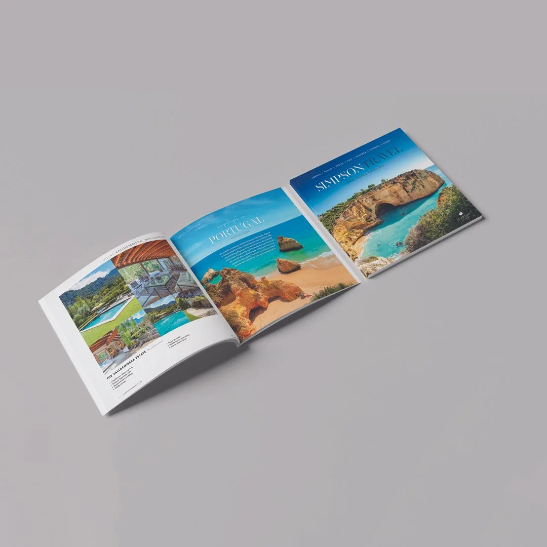Open travel brochure on gray background featuring scenic waterfalls, beaches, and coastal landscapes of Portugal, Simpson Trail, and Valdemossa, Mallorca.