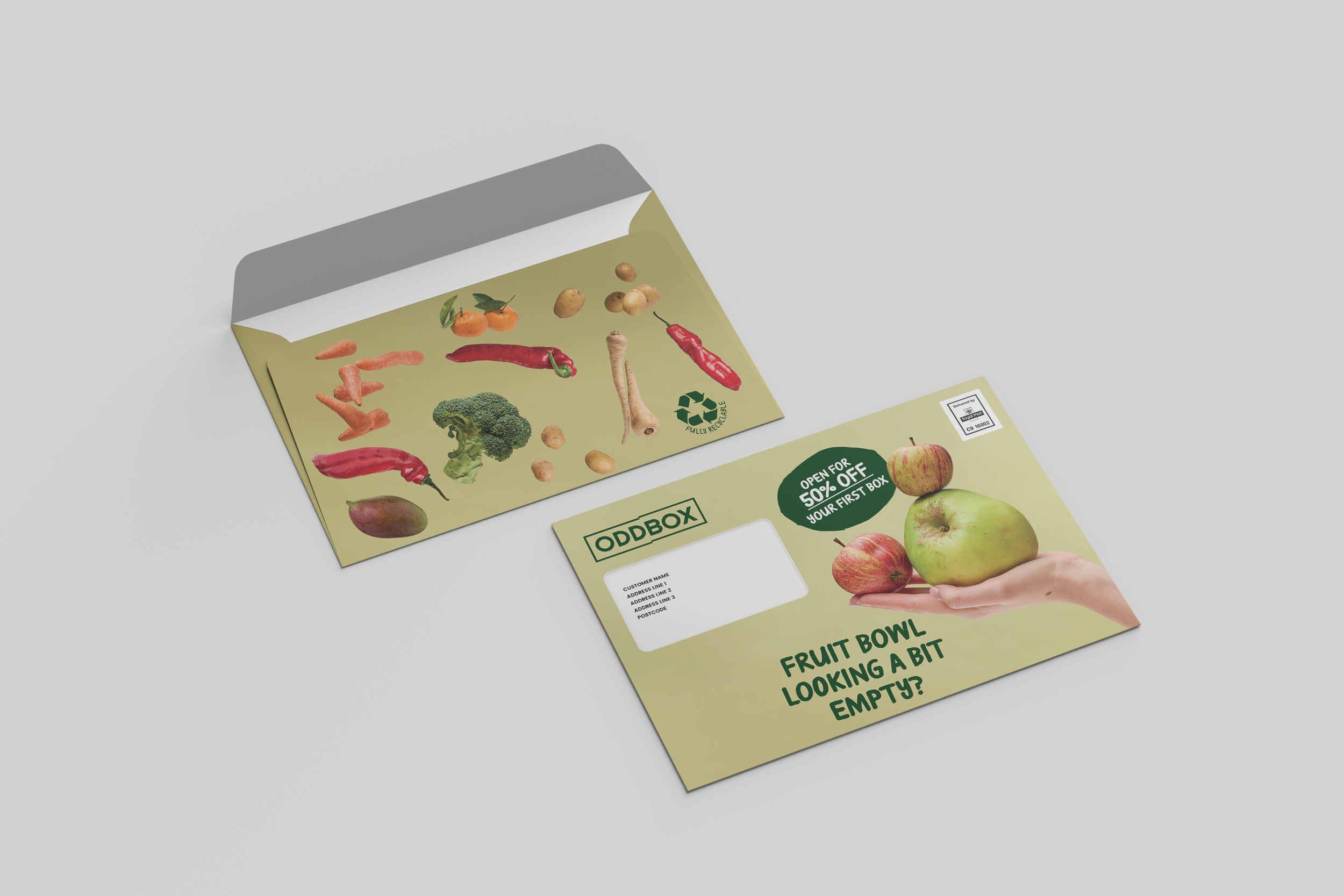 Open box with images of vegetables, fruits, and a flyer promoting shopping discounts, beside a hand holding apples.