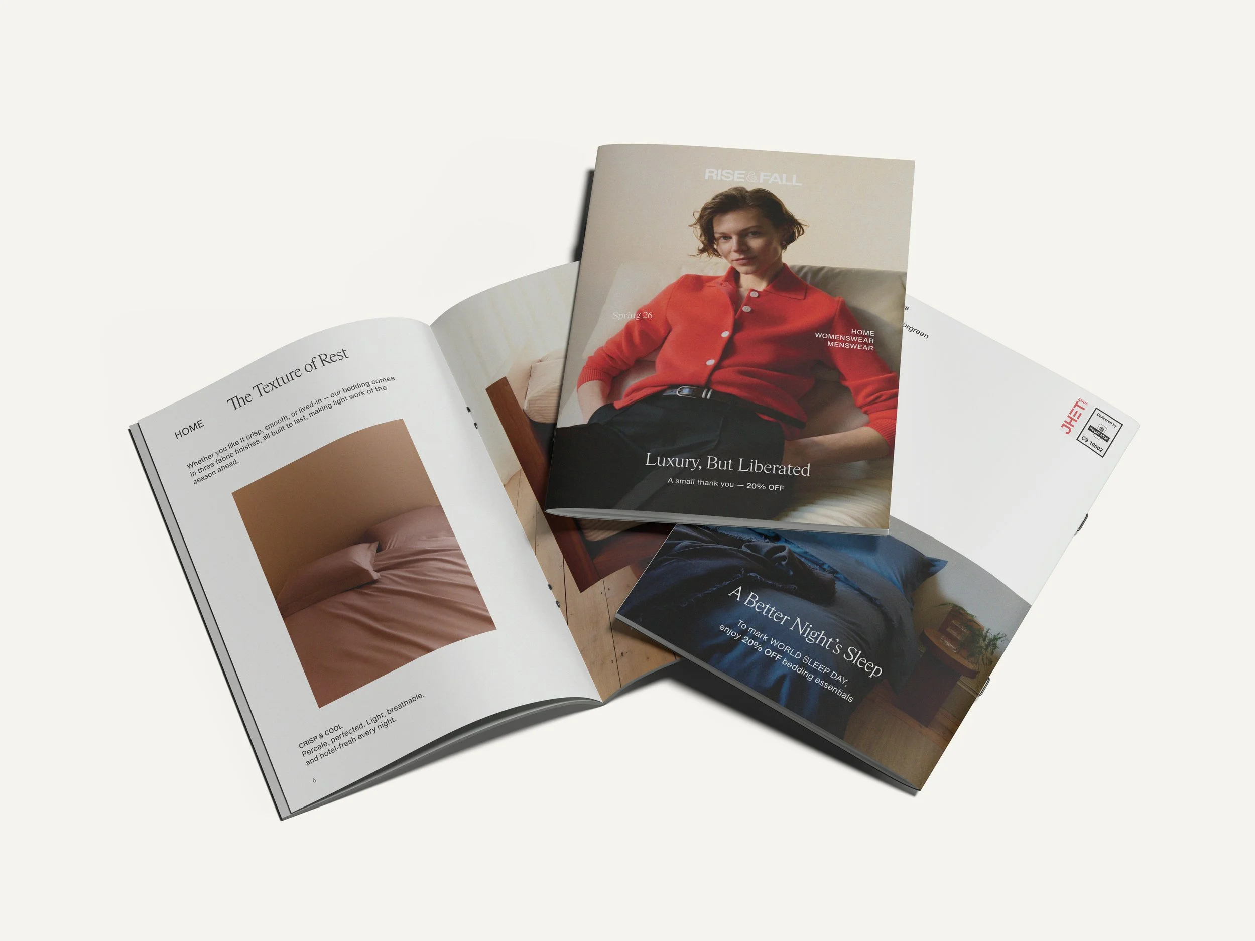 Open magazine with images and articles about home decor, sleep, and clothing, featuring a cover photo of a woman in a red cardigan sitting on a sofa.