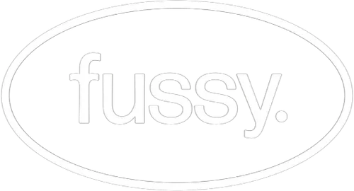 Logo with the word 'fussy' inside an oval shape.