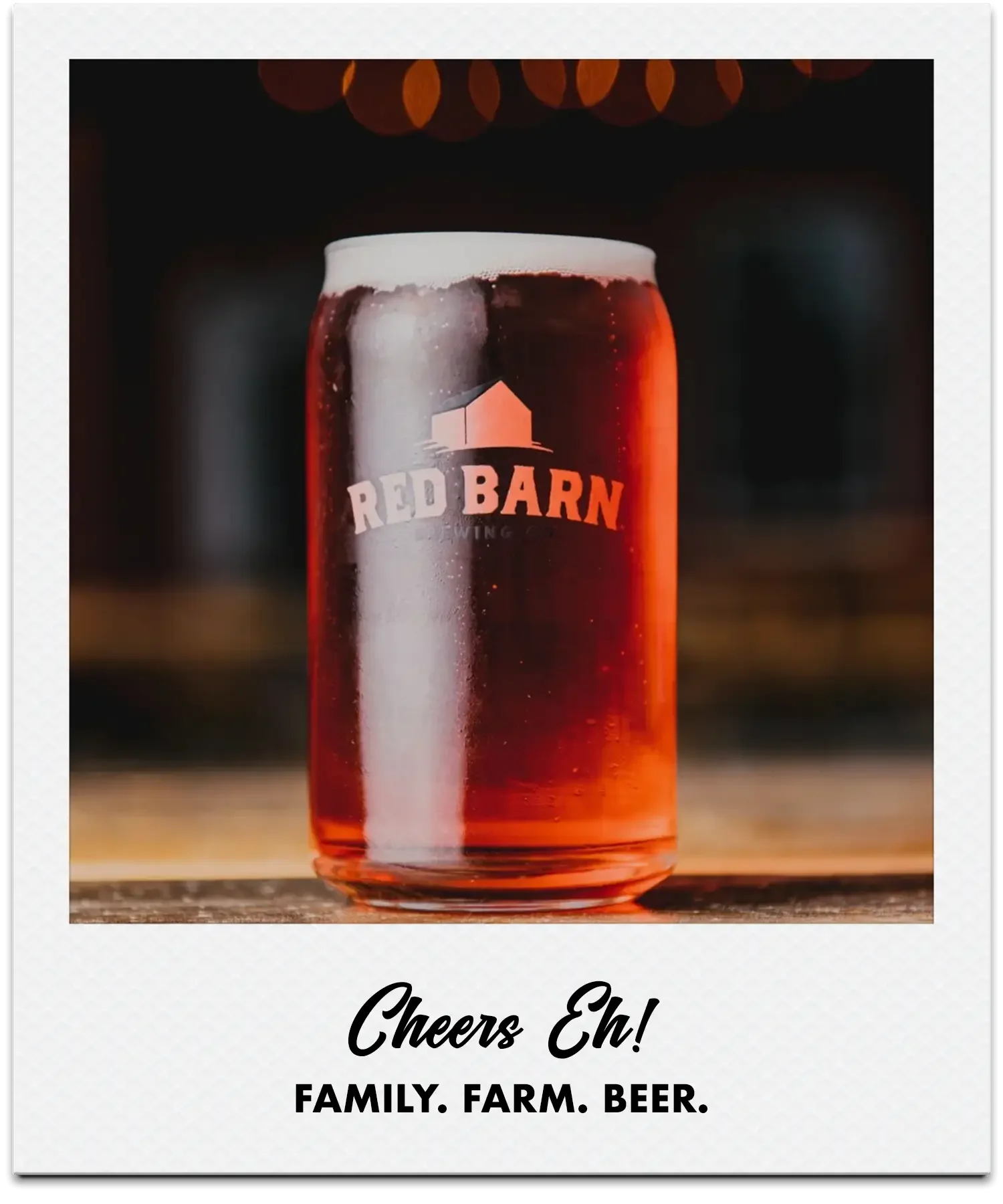 A can of Chatham beer made by Red Barn Brewing Co., with a foamy white head, placed on a wooden surface with background bokeh lights.