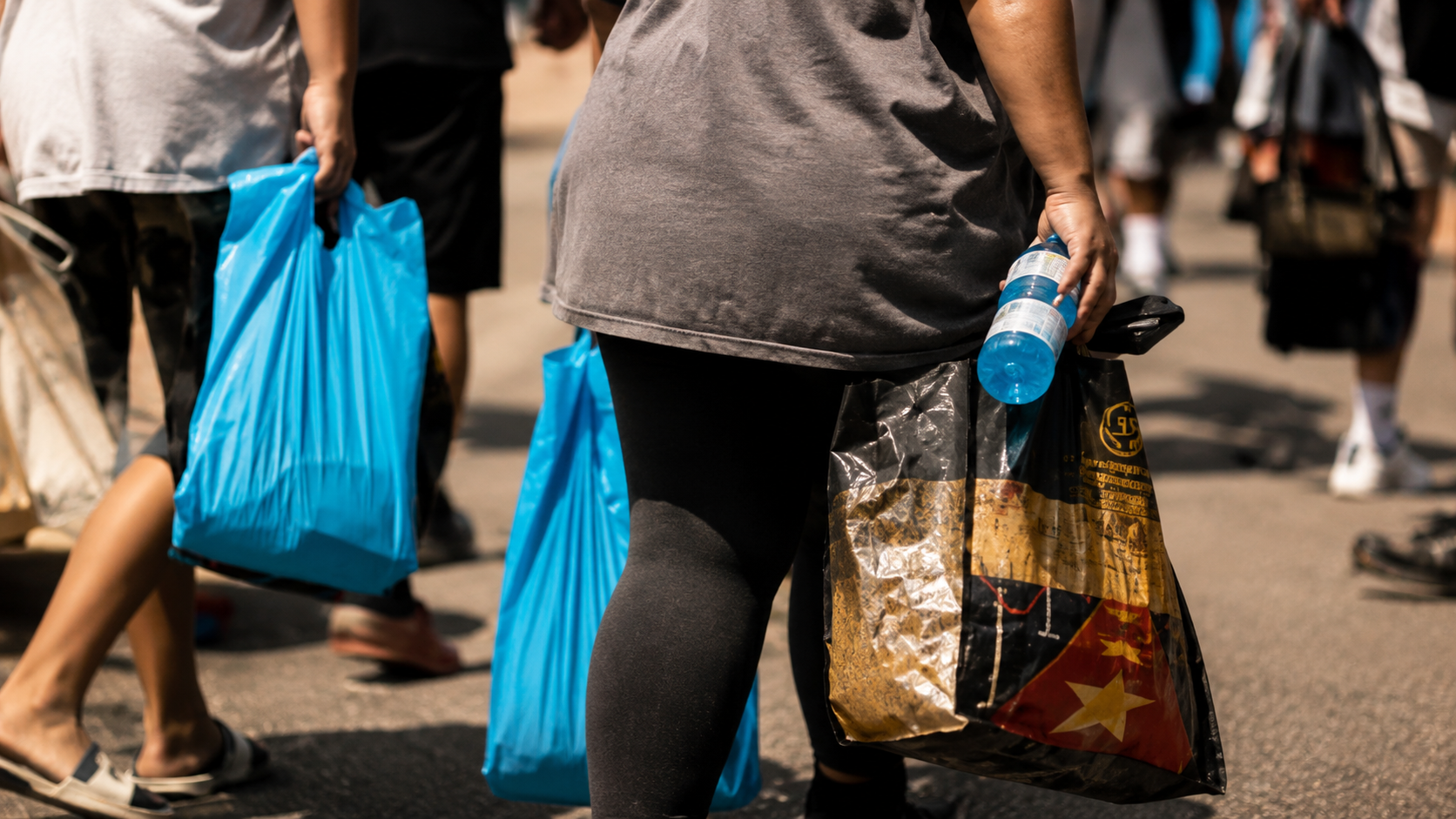 women carrying multiple bags