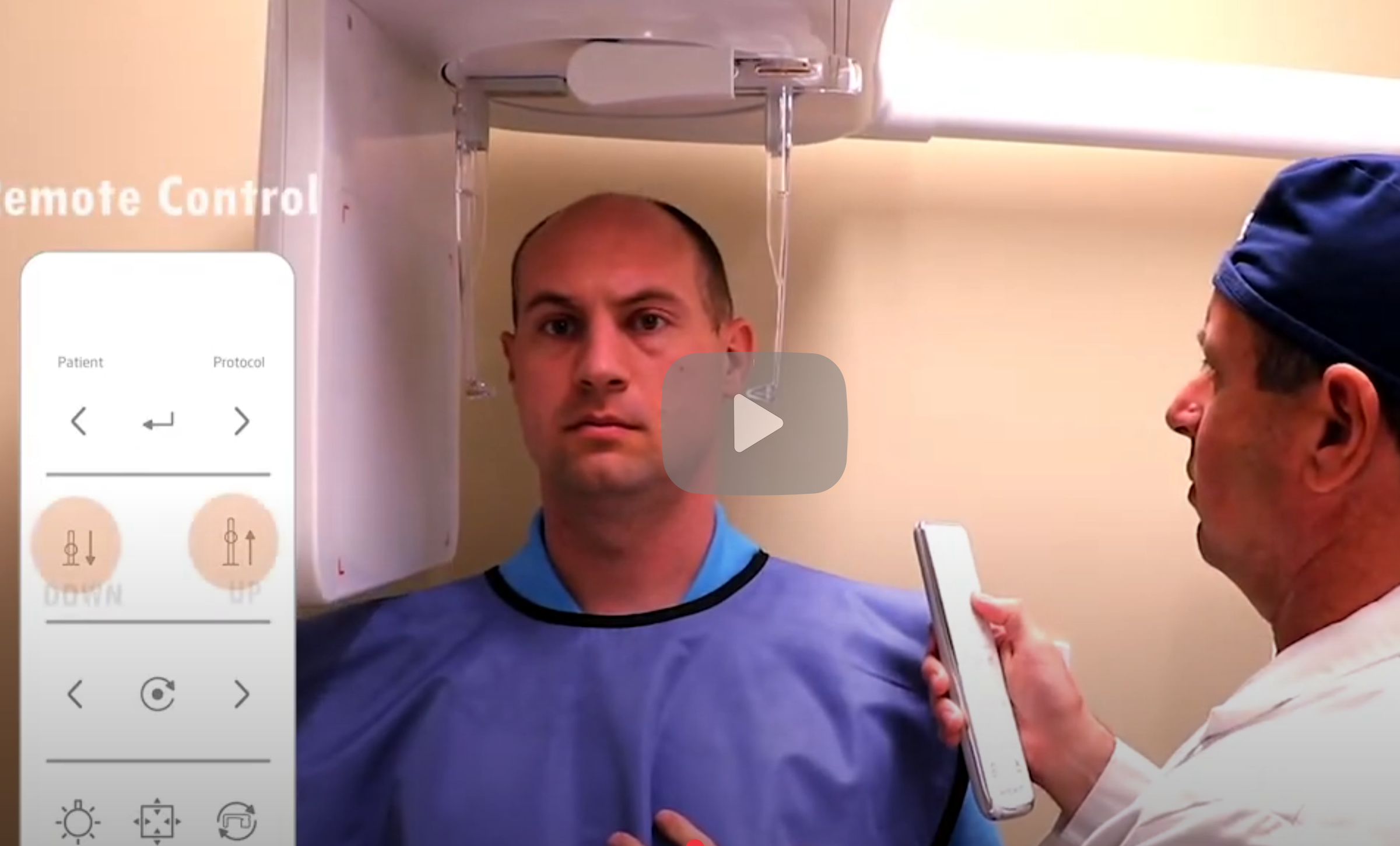 A man undergoing a medical scan or procedure, with a technician holding a remote control and a device near his chest, in a clinical setting.