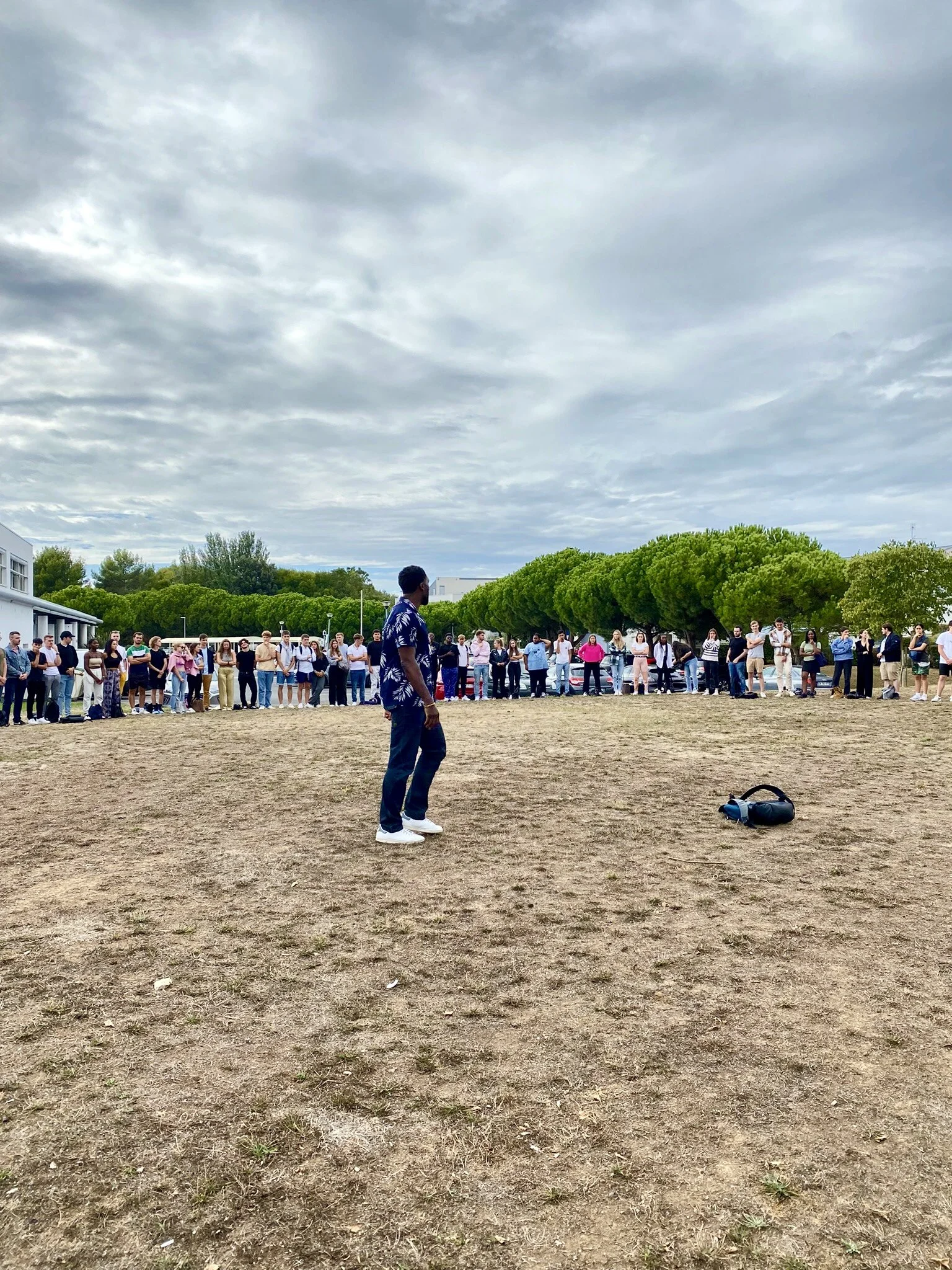 Steven Asei Dantoni Nkoué leads an outdoor group reflection with students.
