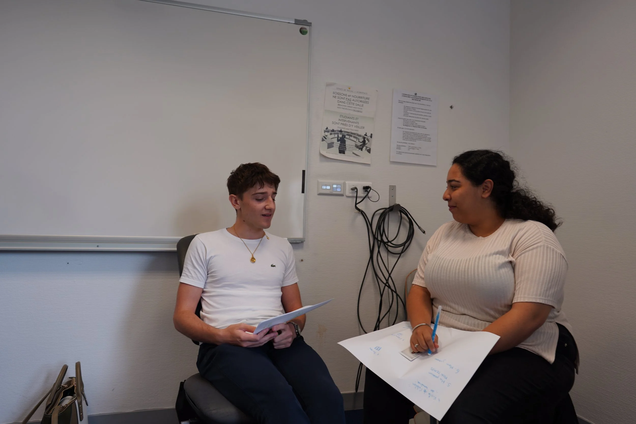 Two participants speak during a facilitated learning conversation.