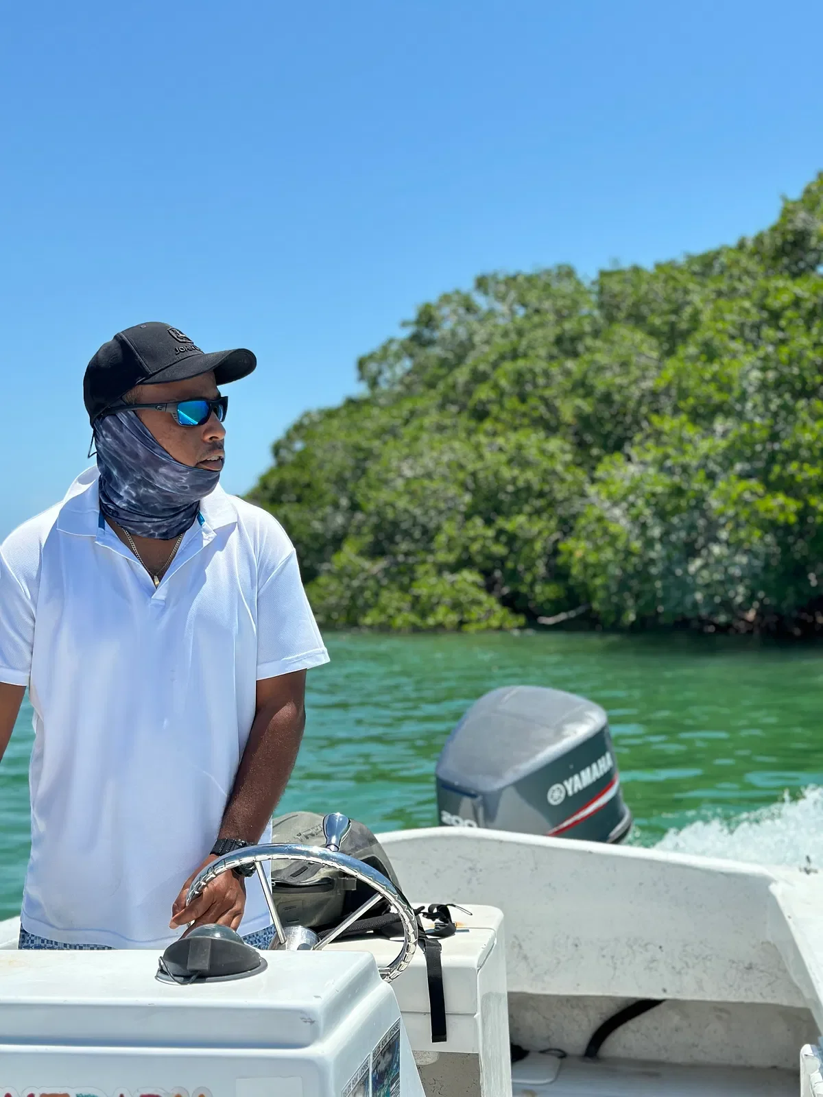 The captain at the wheel of the private boat at Casa Al Mar.