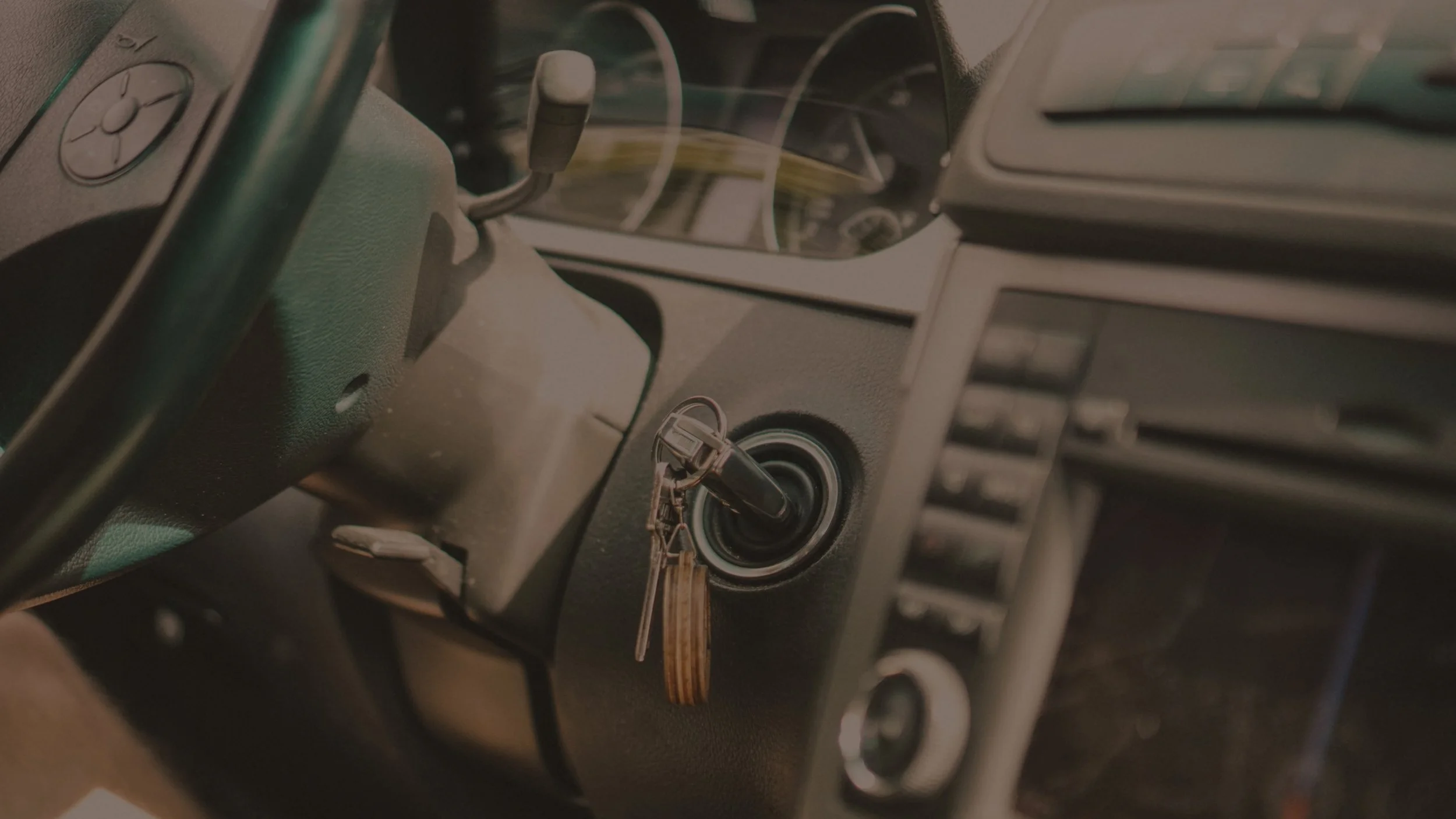 Close-up of a car interior with a key in the ignition.
