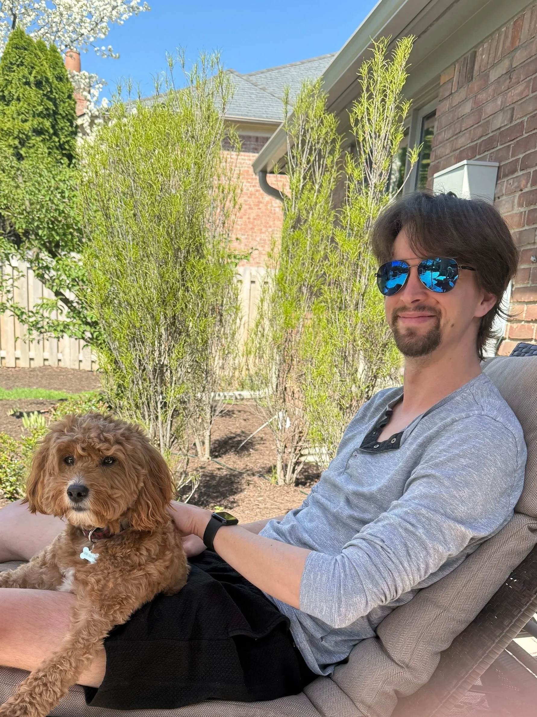 Me with my mom's dog Samson, sitting on her backyard porch.