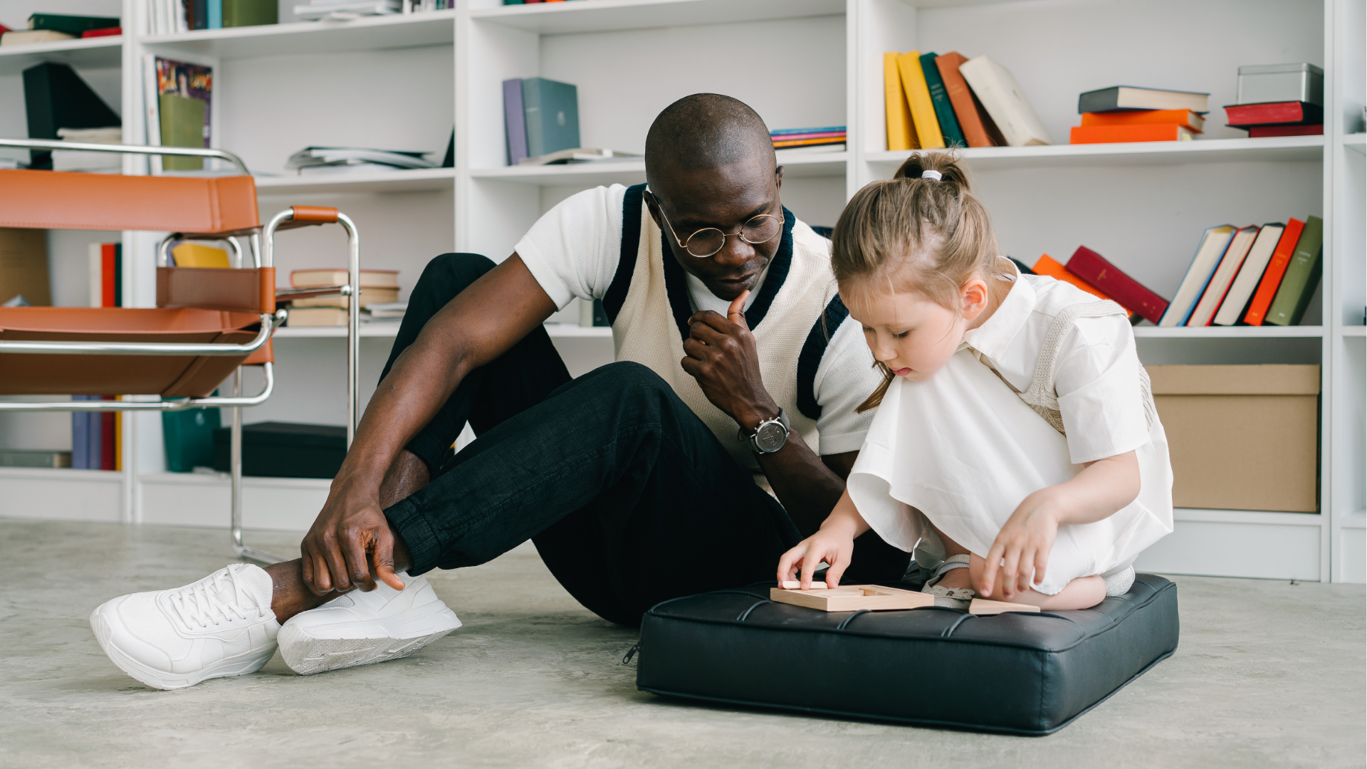 African American male therapist working with little girl