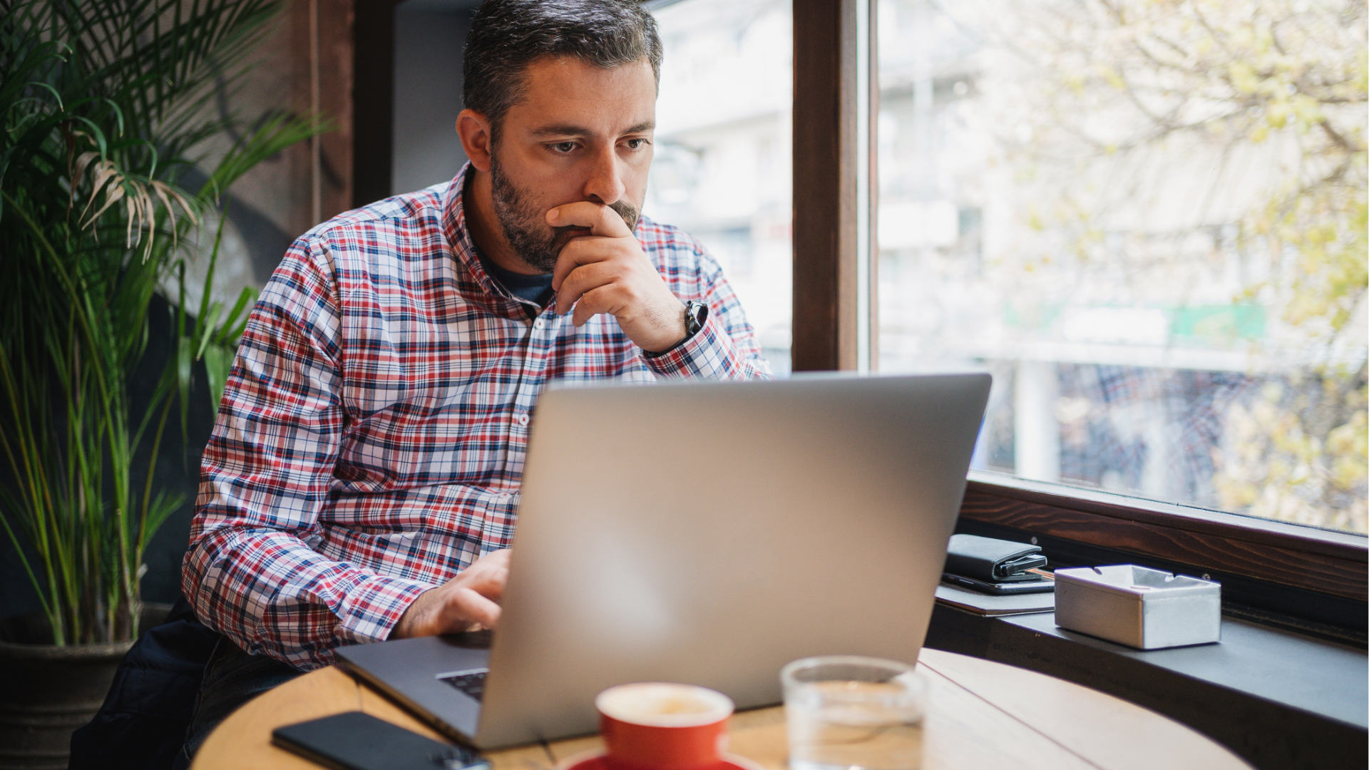white man looking at a laptop 