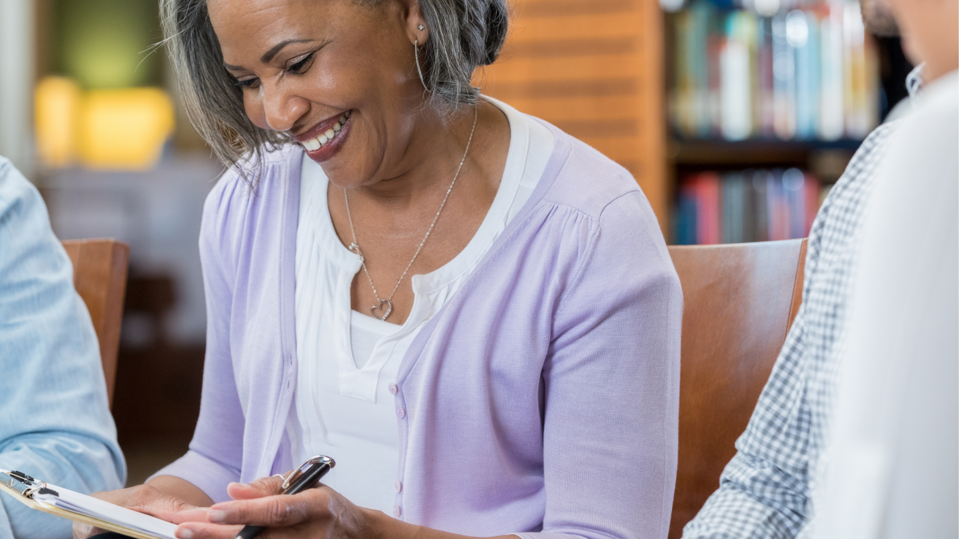 Middle-age African American woman looking at a notebook