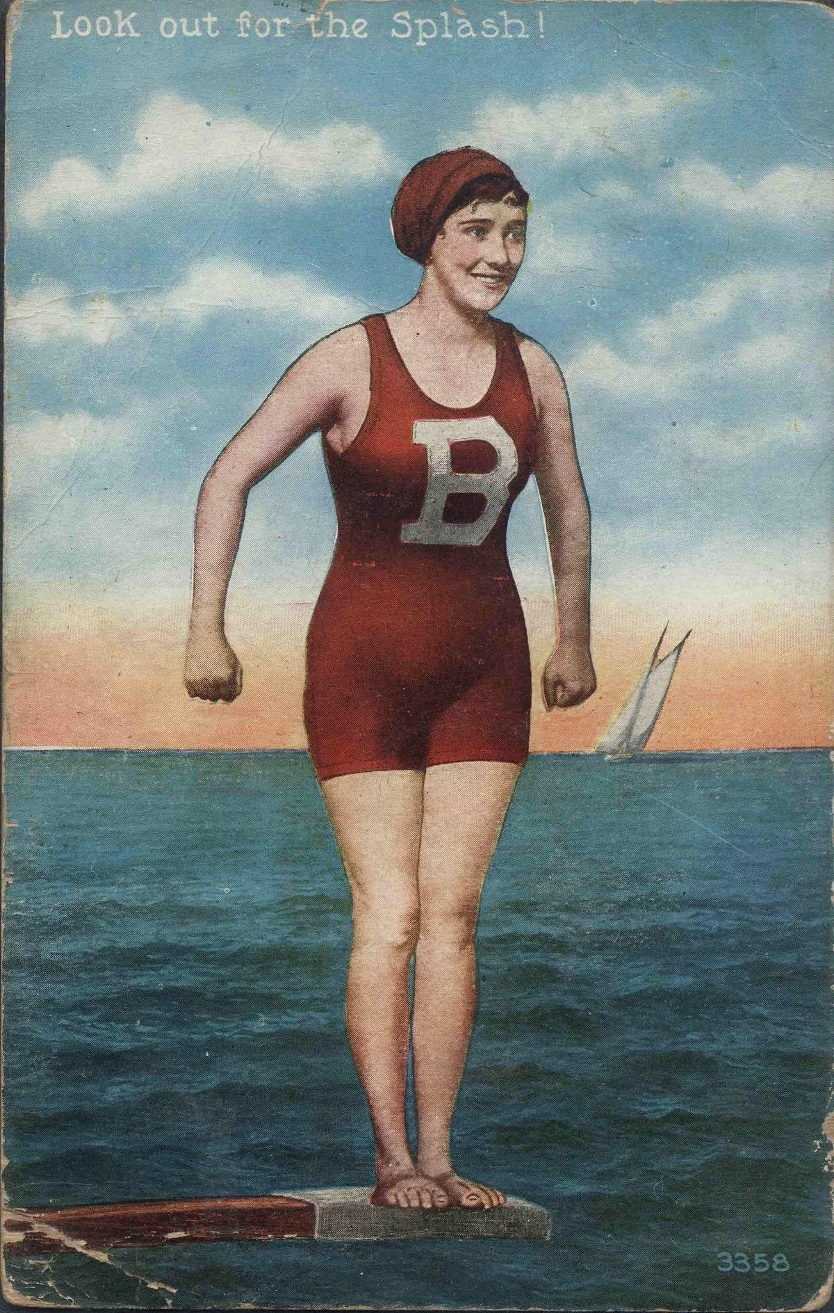 A painted postcard of a 1920s woman in a red bathing suit and cap. She stands on the edge of a diving board, smiling, the ocean behind her. Hand lettering at the top of the image reads, "Look out for the Splash!"