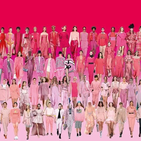 Group of diverse models in pink and pastel-colored fashion on a pink background