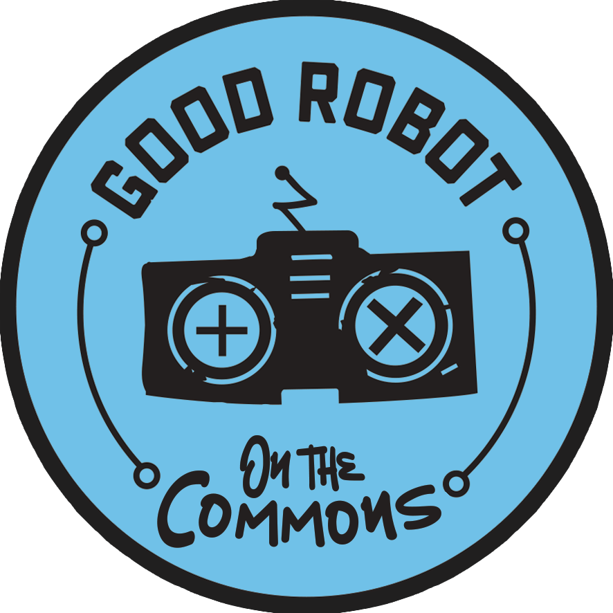 A round blue logo with black border, featuring a black robot controller with plus and X buttons. Text reads 'Good Robot on the Commons' in black, with a circuit-like line connecting the text and controller.
