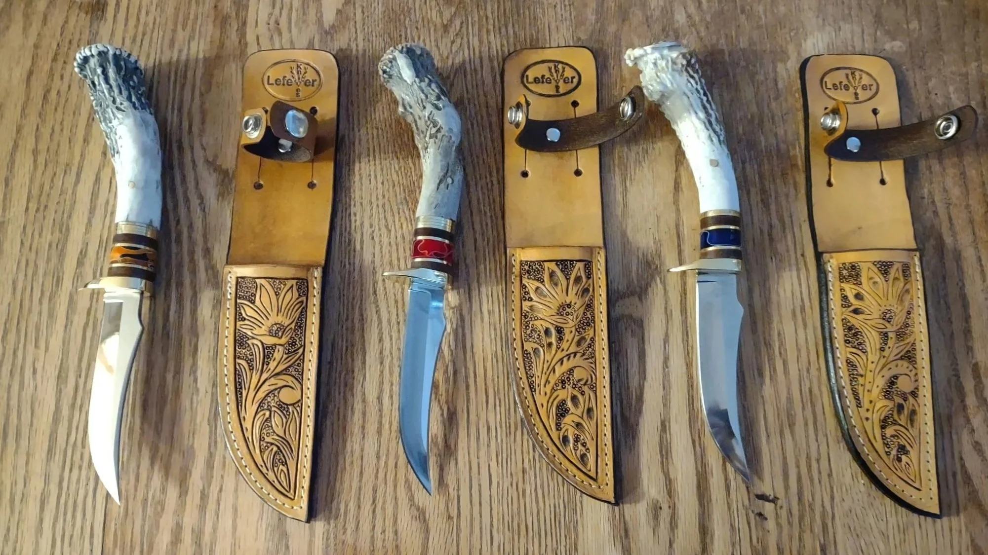 Custom Knives with elk antler handles accompanies by custom made leather sheaths.
