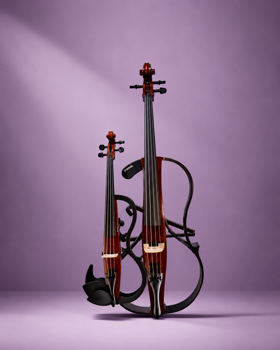 Two violins on a black metal stand against a purple background.