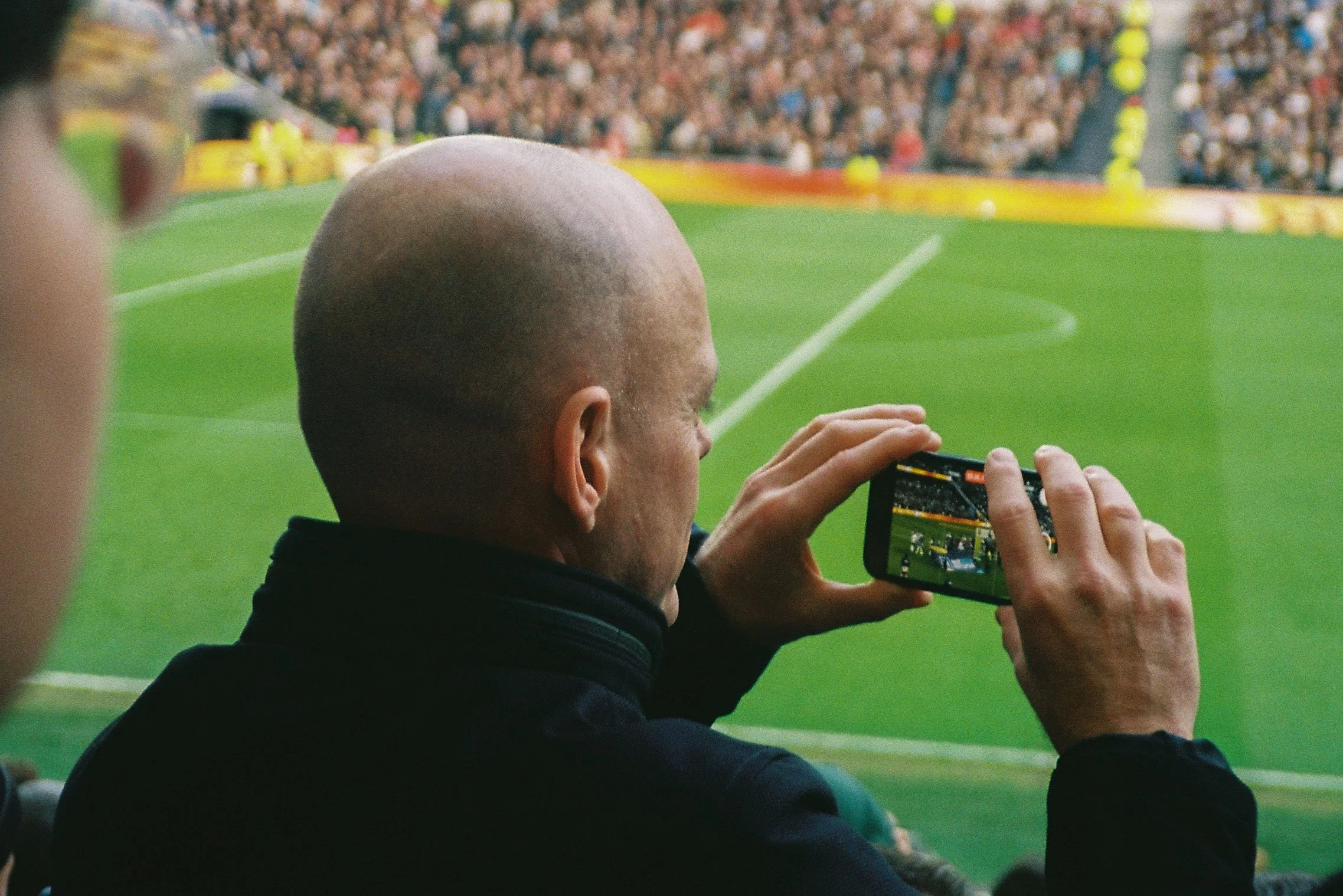 bald man taking photo west ham.jpg