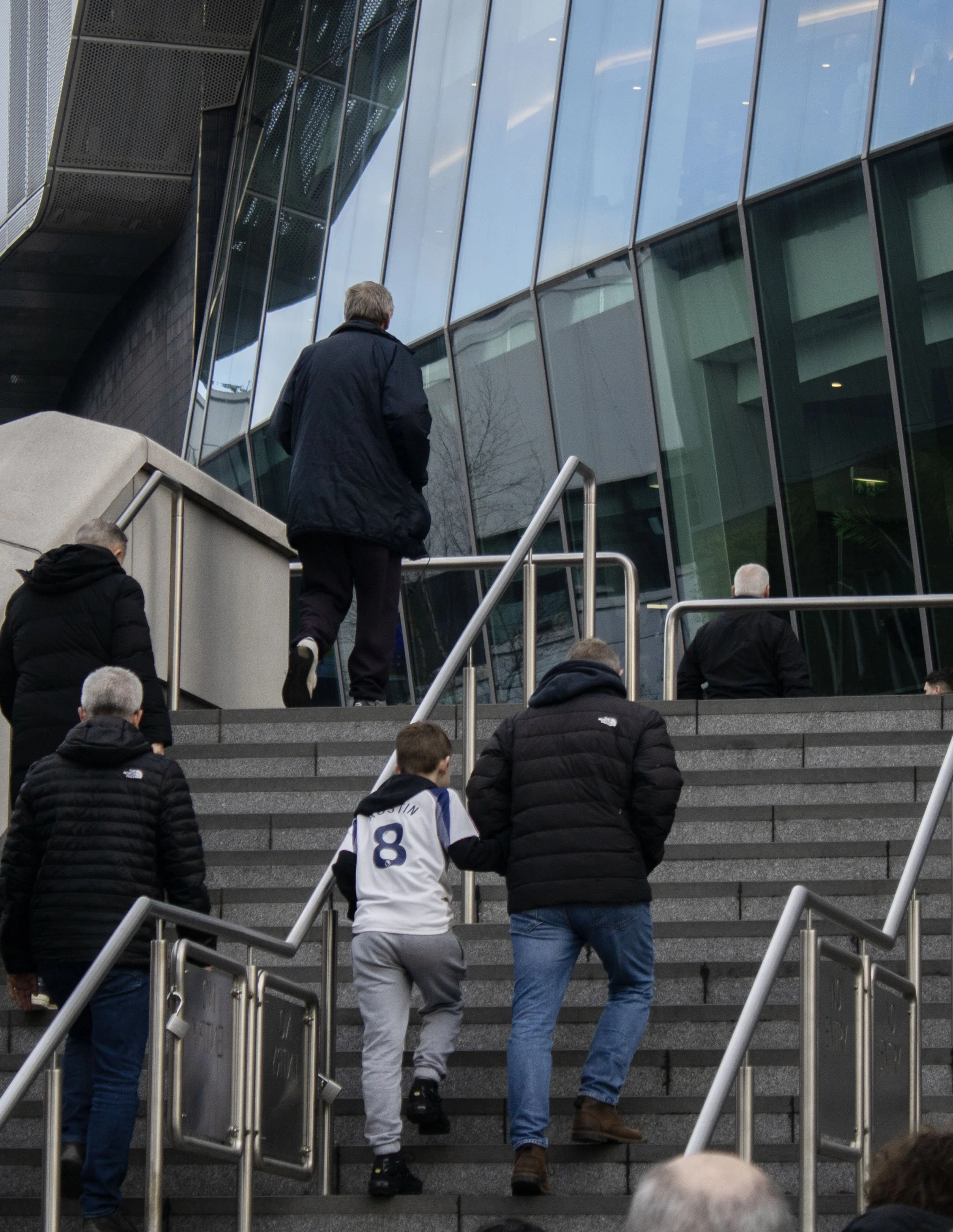boy walking up stairs to stadium .jpg