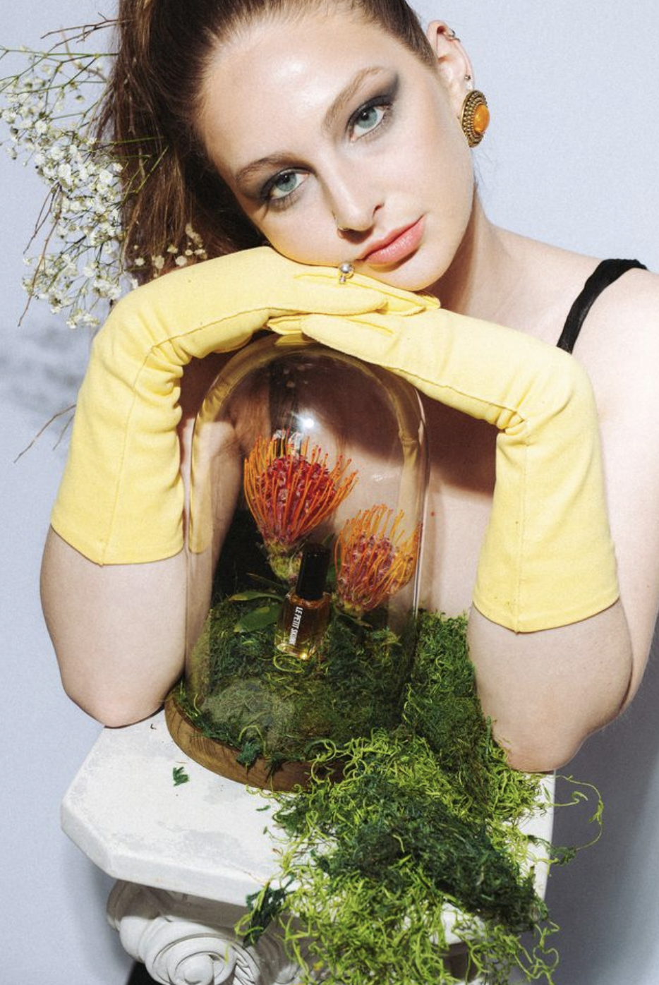 yellow opera gloves over le petit skunk display in cloche