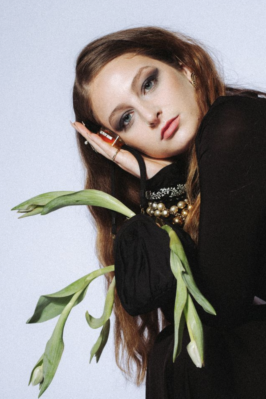 model with accessories, tulips, and handbag