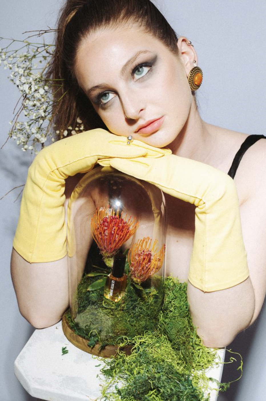 yellow opera gloves over le petit skunk display in cloche 3