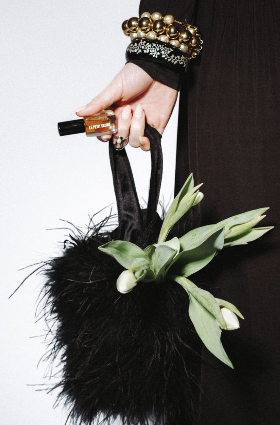 black feather handbag, white tulips, le petit skunk, wrist accessories
