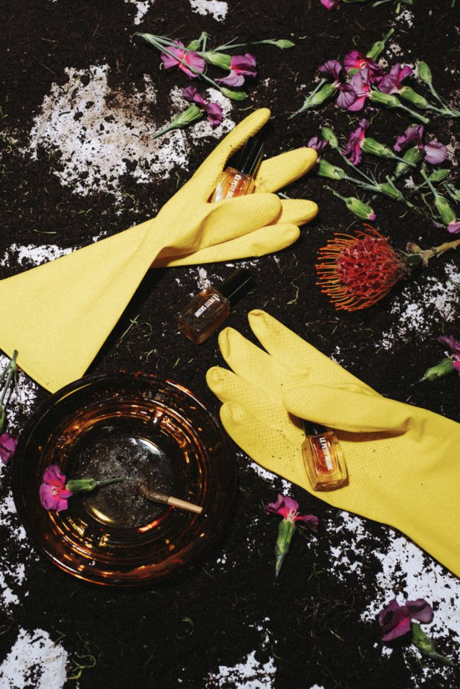 yellow cleaning gloves with flowers and ashtray with a joint to nod to le petit skunk's smoky, earthy fragrance