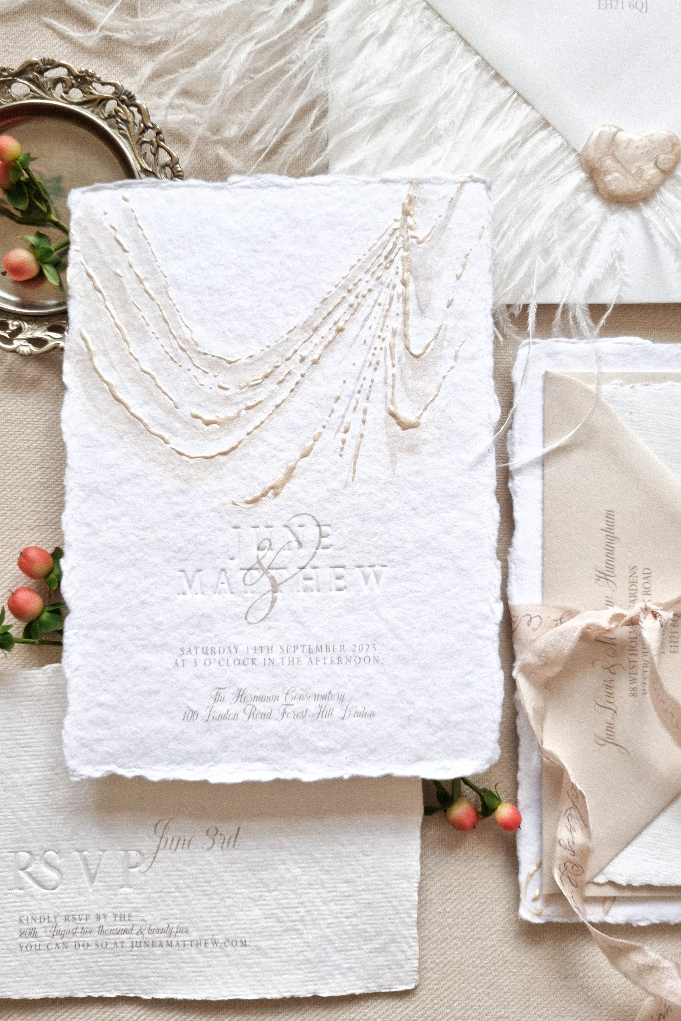 hand made paper wedding invitation with blind emboss printing.