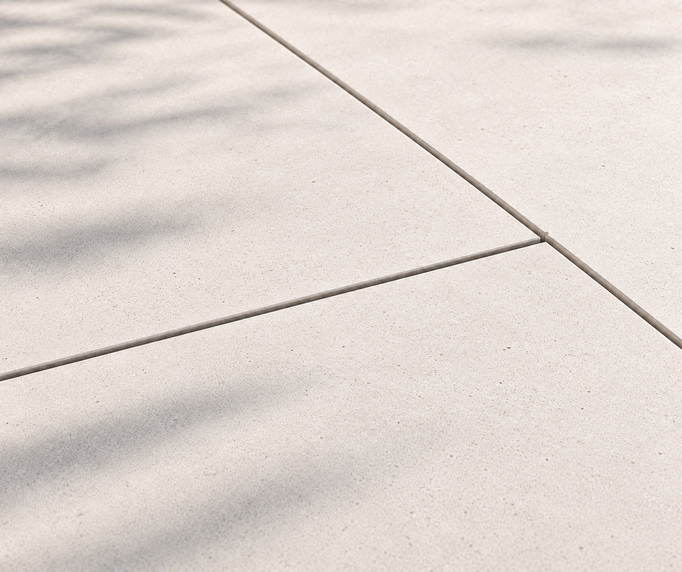 Close-up of light-colored tiled floor with shadows of a plant.