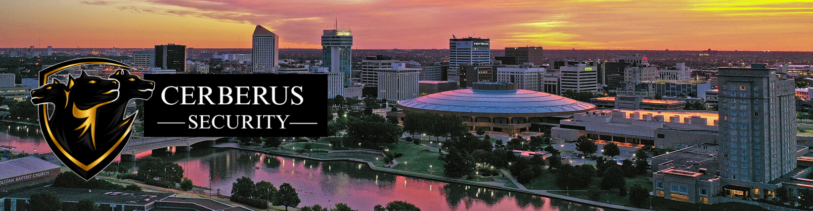 City skyline at sunset with Cerberus Security logo featuring three black and gold dog heads and a shield.