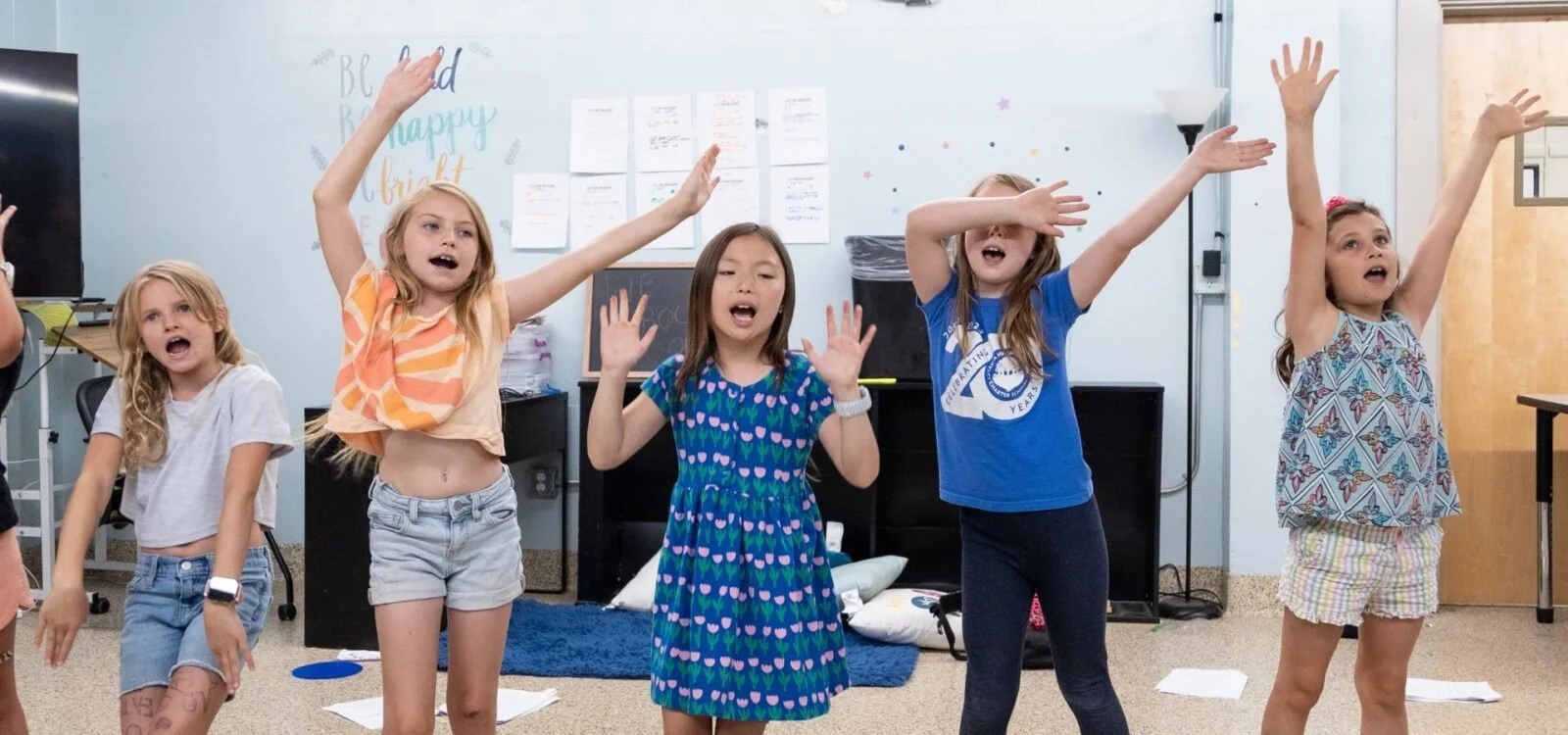 Young performers singing together at Alliance Theatre