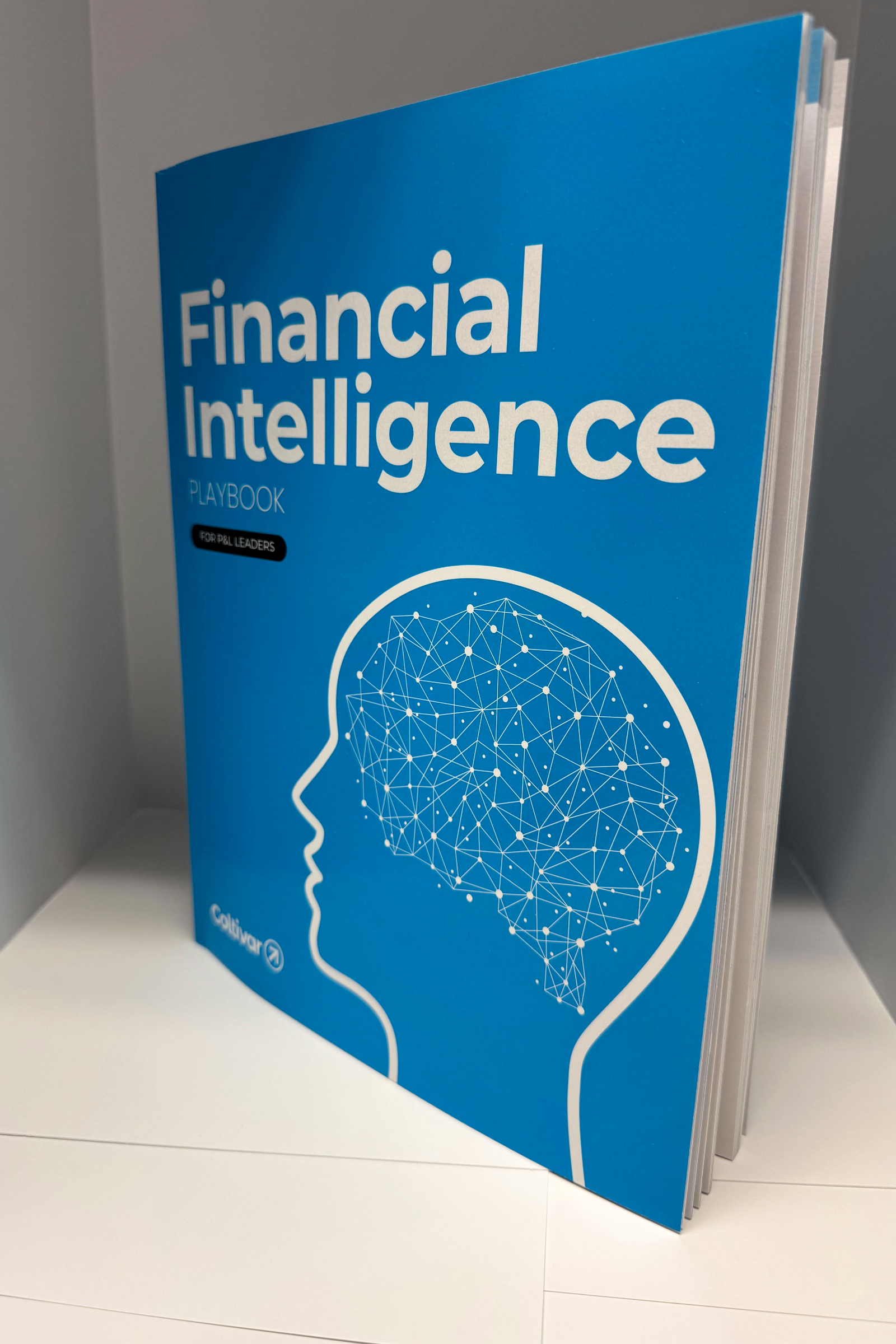A blue book titled 'Financial Intelligence Playbook for P&L Leaders' featuring a white outline of a human head with a network of interconnected nodes inside.