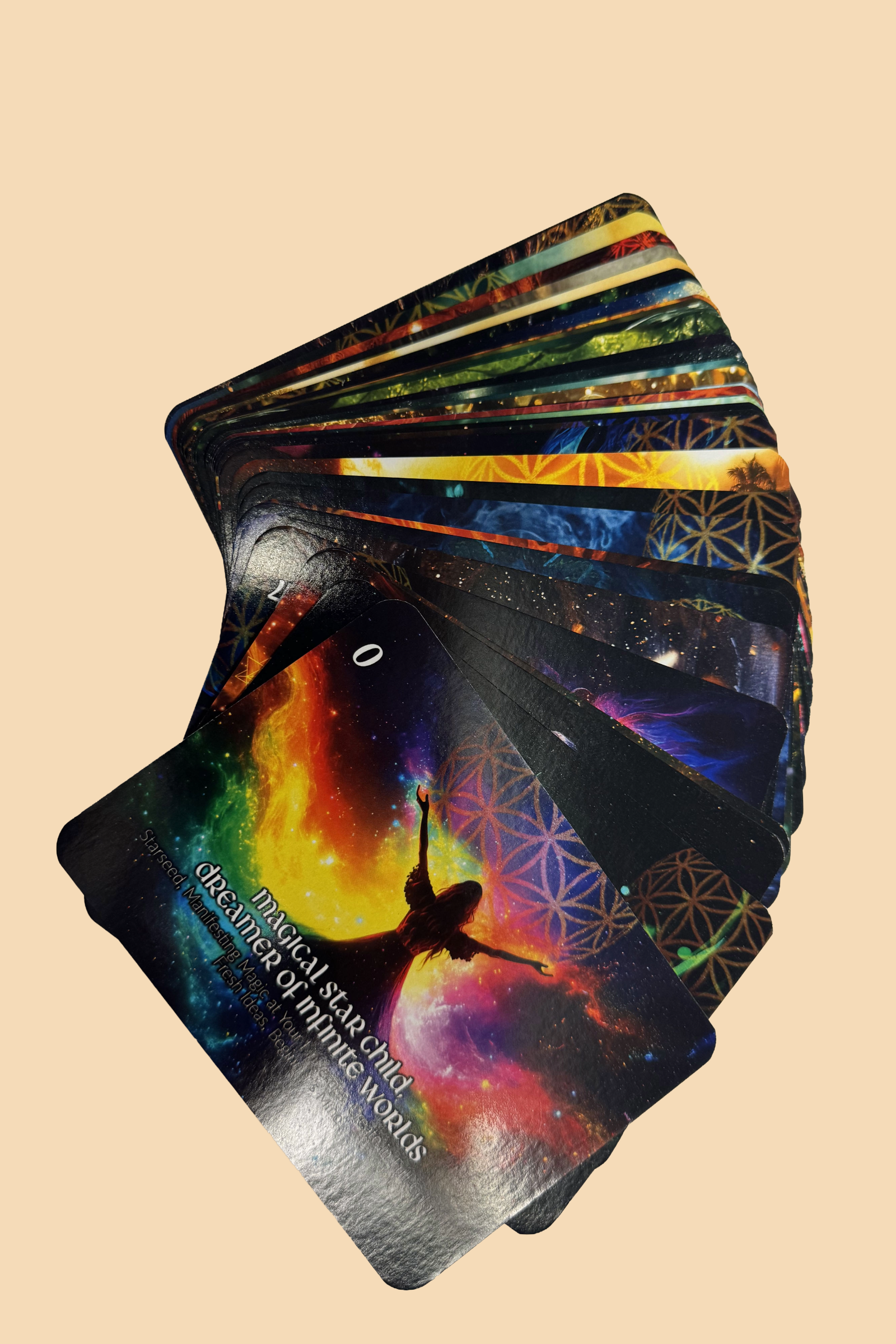 A deck of colorful oracle or tarot cards fanned out against a plain background. The visible card features a silhouette of a woman with raised arms, surrounded by a cosmic, rainbow-colored backdrop with text referencing spiritual themes.
