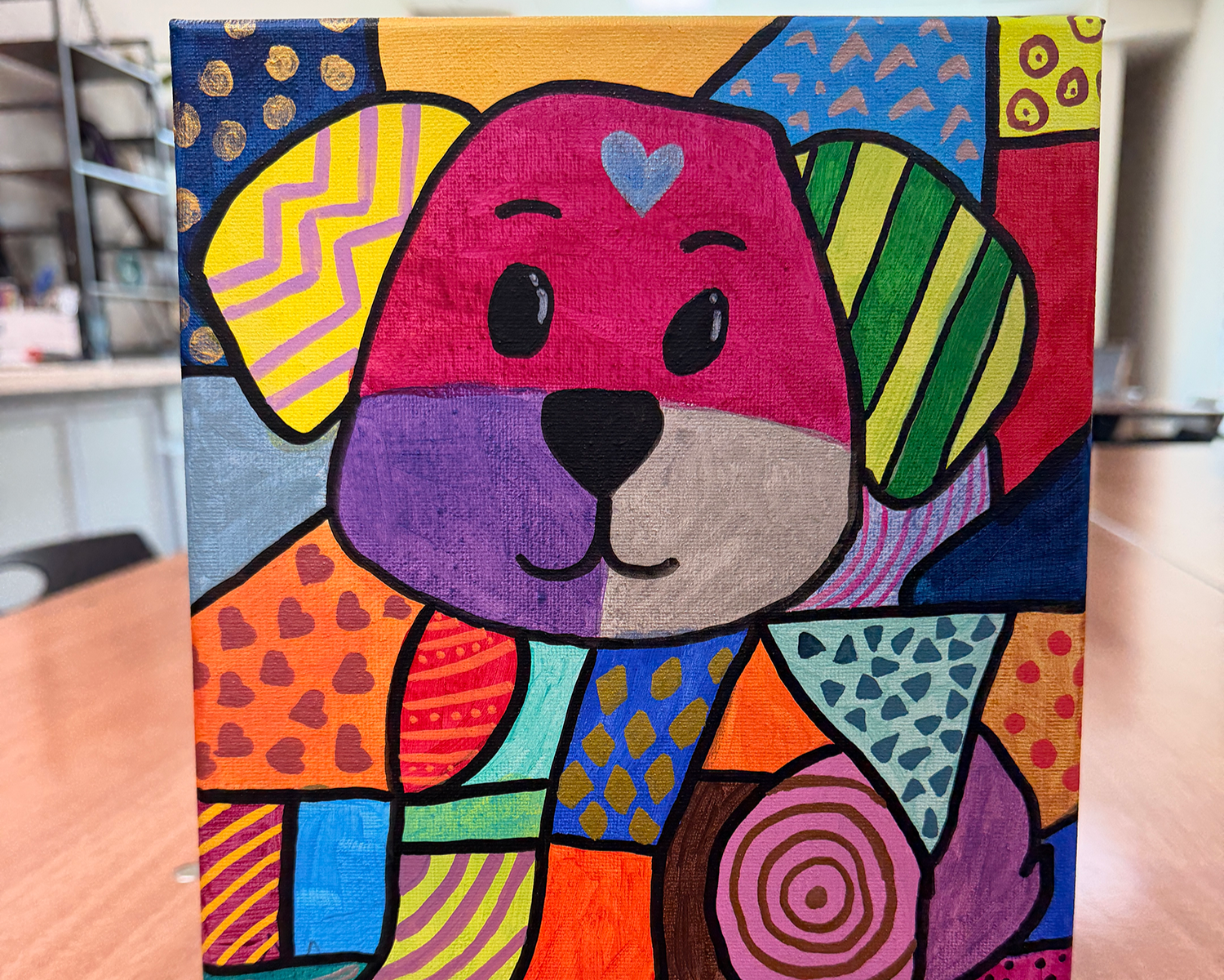 Close-up on someone painting acrylics on canvas.