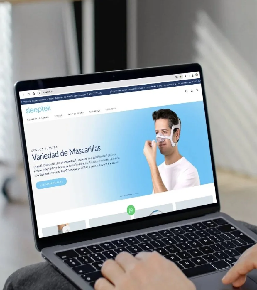 Laptop screen displaying a website about sleep masks, showing a man wearing a sleep mask for CPAP therapy.