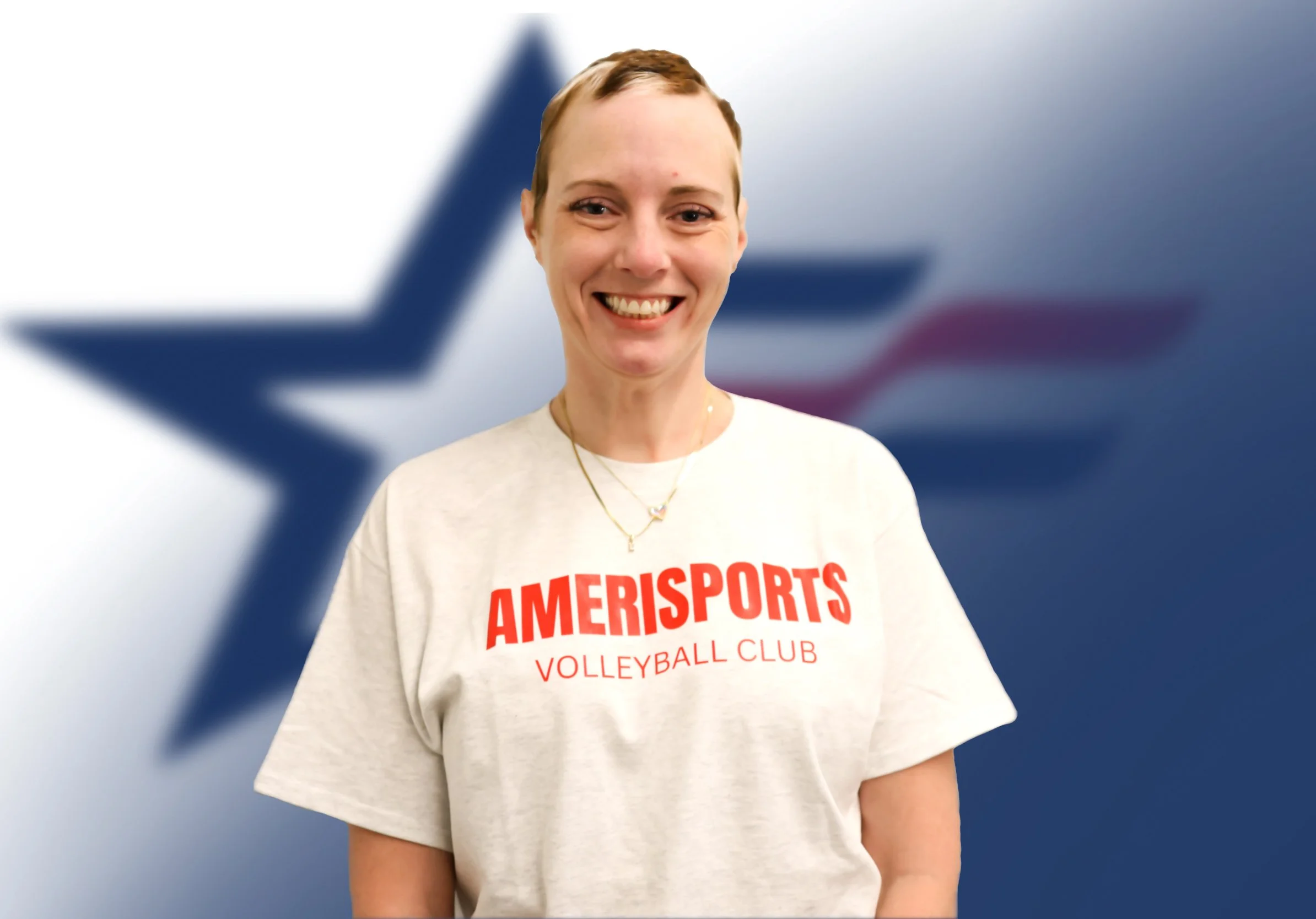 A smiling person with short brown hair standing in front of a blurred background featuring a large star symbol. The individual is wearing a white T-shirt with red text that reads 'AMERISPORTS VOLLEYBALL CLUB' and a gold necklace.