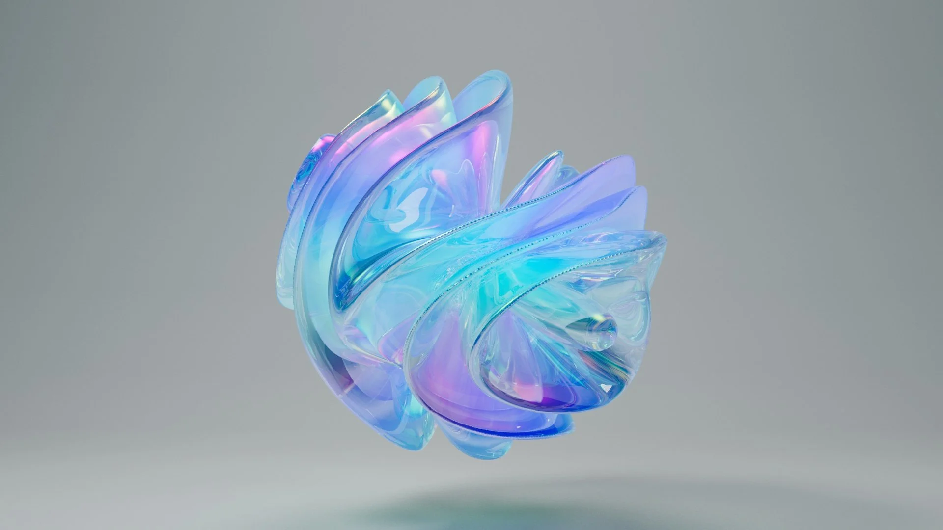 Abstract iridescent glass sculpture with swirling, feather-like shapes in pastel colors on a neutral background.